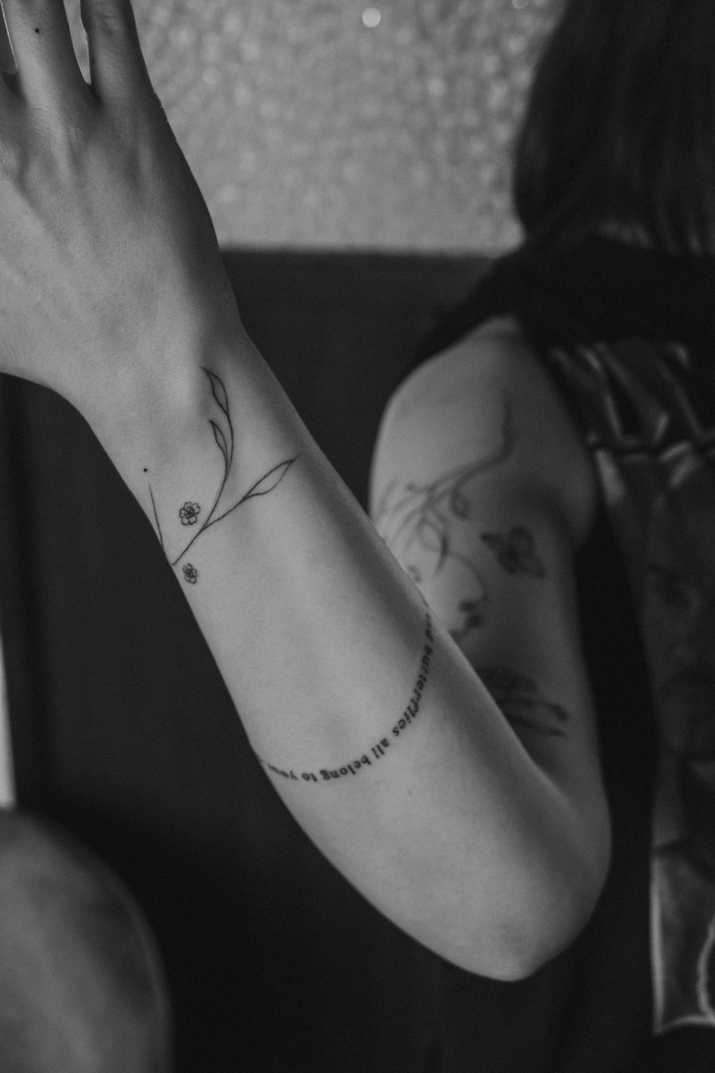 Close-up of a person's arm with fineline tattoo sleeve done delicately by Ola Getka in Reykjavik, in black and white.