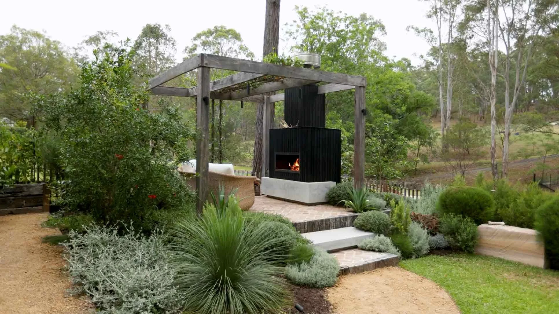 Fire pit area surrounded by greenery