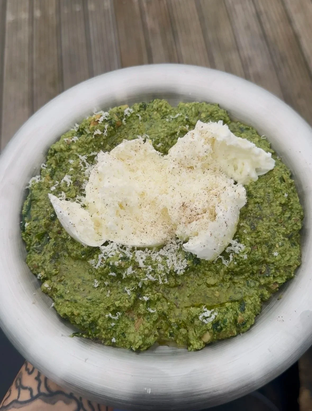 Homemade super seed pesto recipe on plate with fresh basil and burrata