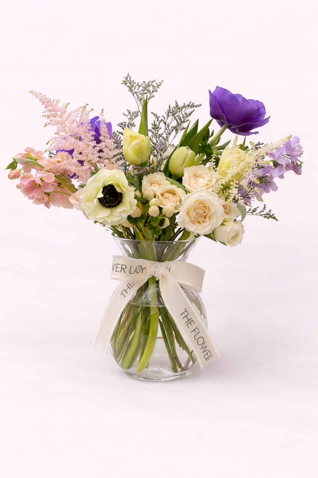 Elegant floral bouquet in glass vase.png