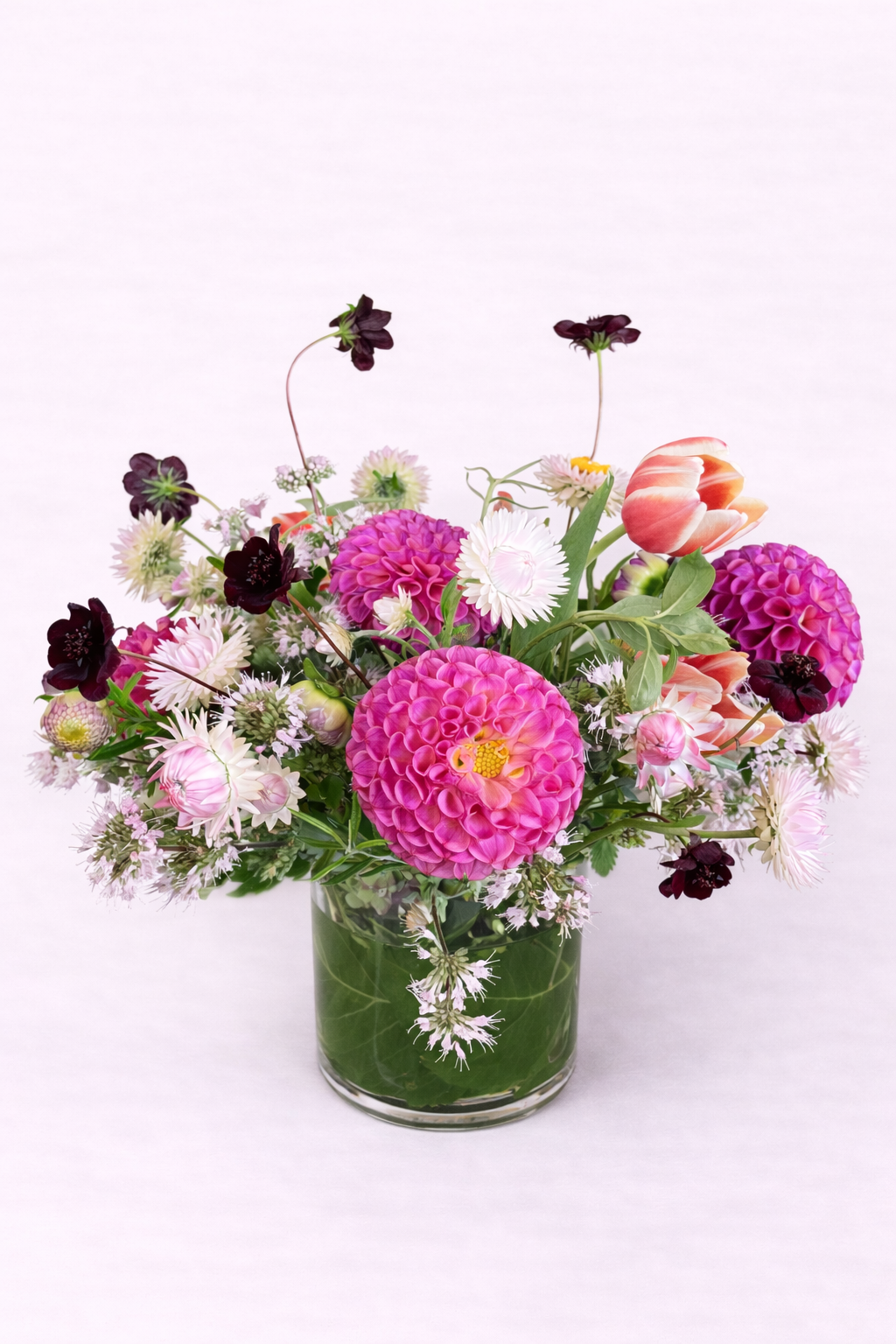 Vibrant floral arrangement in glass vase.png