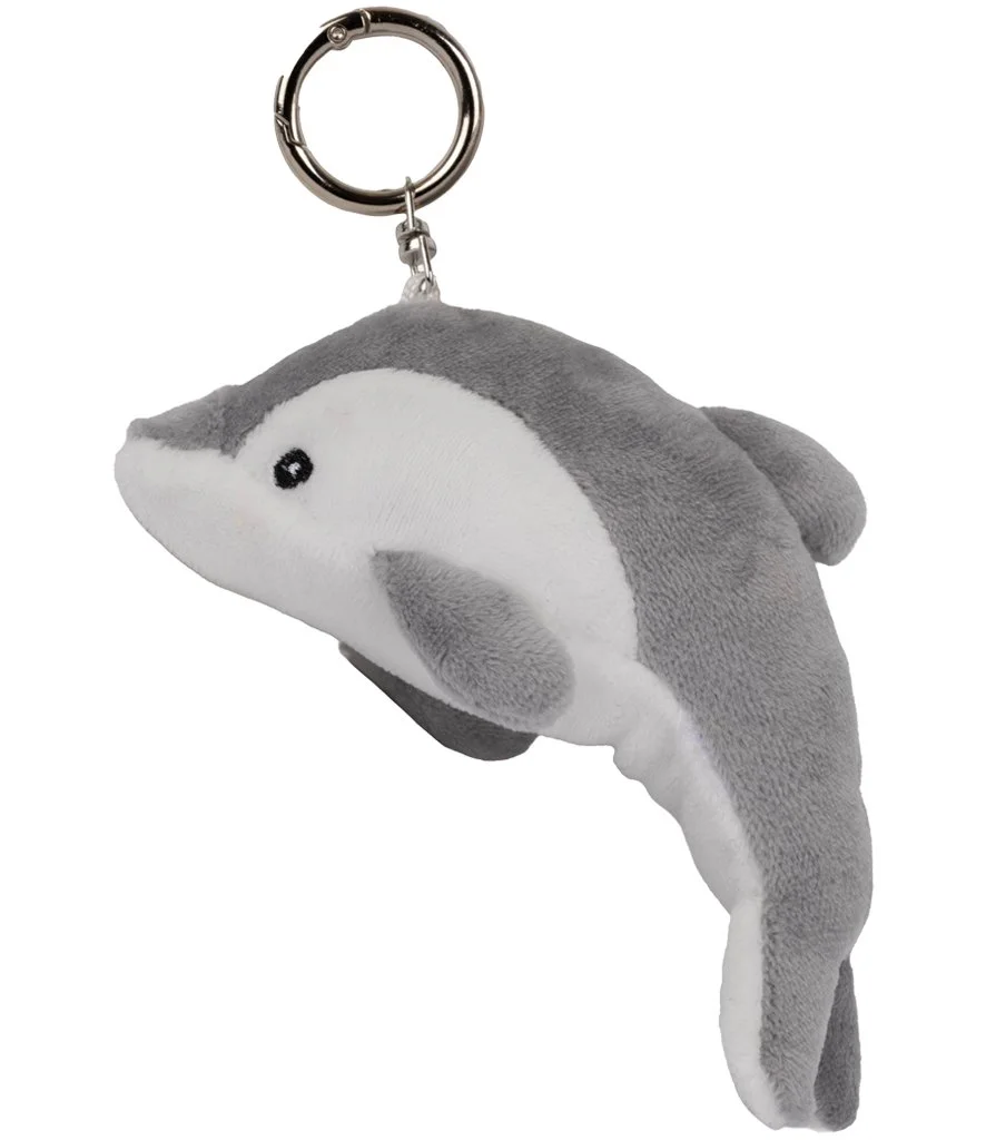 Grey and white dolphin plush keychain with embroidered details, attached to a metal key ring for bags or keys.