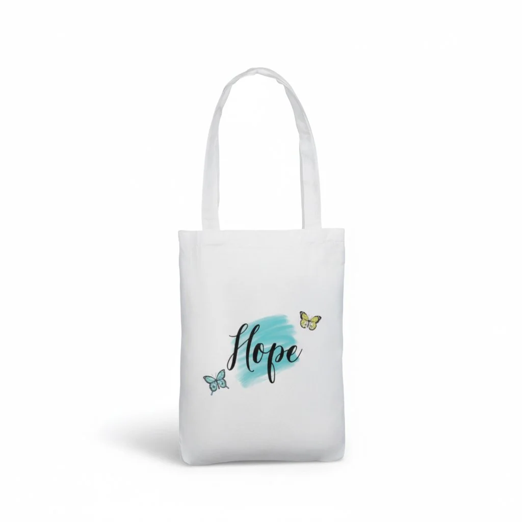 White tote bag with the word ‘Hope’ in elegant script over a soft blue brushstroke, decorated with two colourful butterflies.