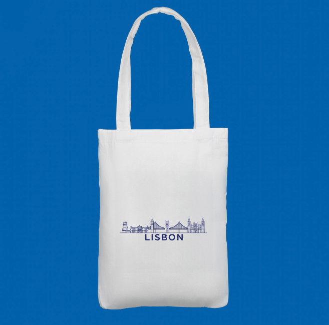 A premium white tote bag featuring a blue minimalist skyline of Lisbon. A stylish accessory inspired by Portugal’s capital.