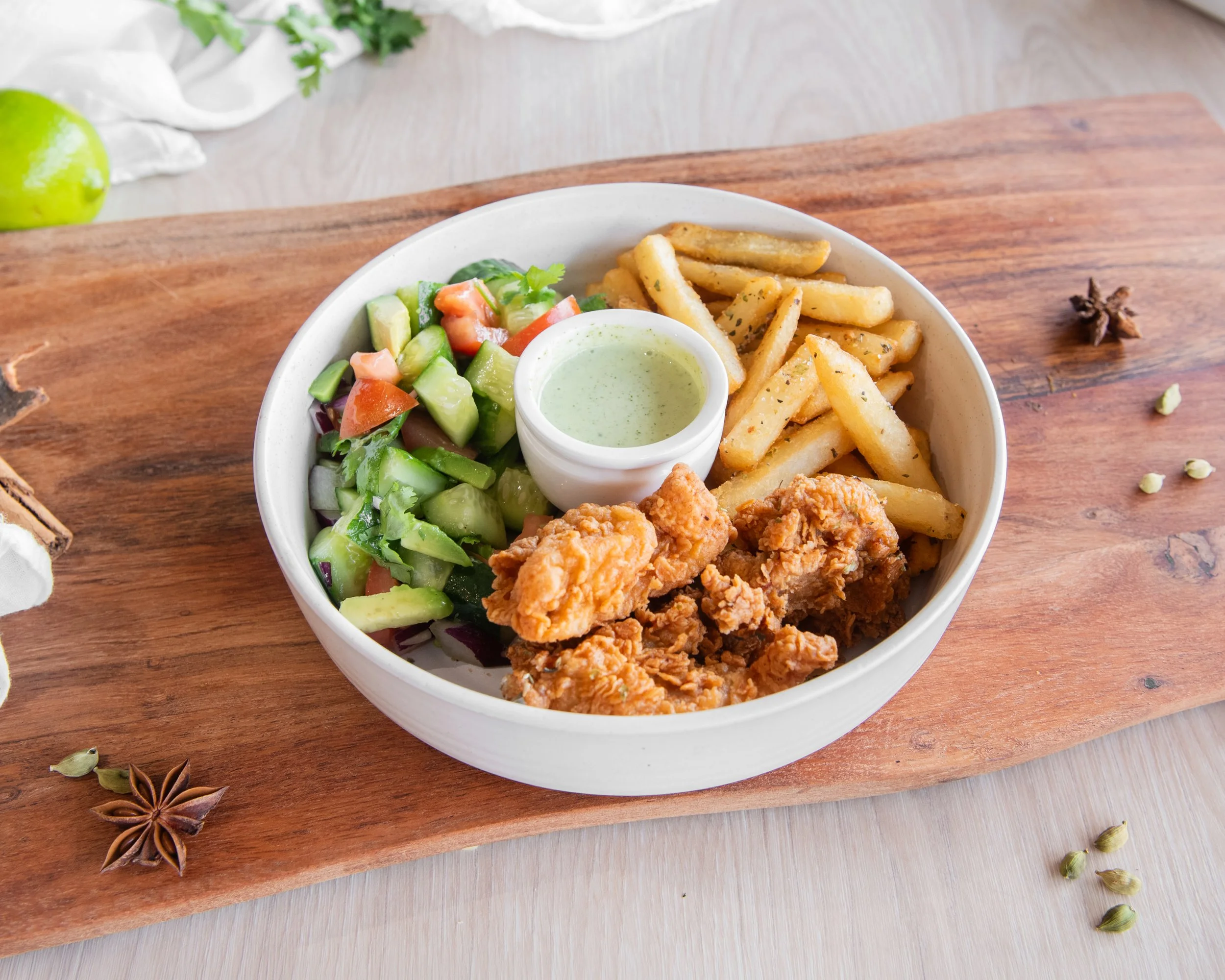 Crispy fried chicken protein bowl loaded with fresh salad, spiced chips, and house-made sauces. This protein, flavour-packed bowl features golden crunchy chicken, vibrant veggies, and bold Bangladeshi-inspired spices for the perfect healthy comfort m
