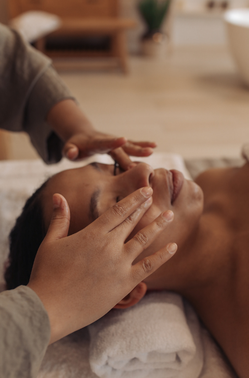 Person receiving a facial massage or skincare treatment at spa.