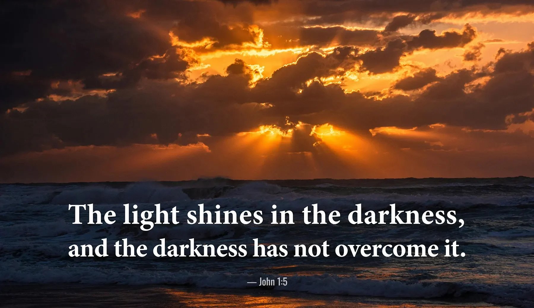 John 1:5 Bible verse over ocean sunset with rays of light shining through clouds.