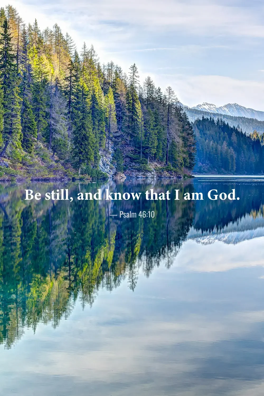 Psalm 46:10 Bible verse over a tranquil mountain lake surrounded by evergreen forest.