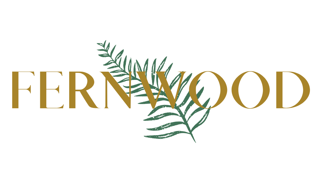 Fernwood logo with gold text and green fern leaf illustration.