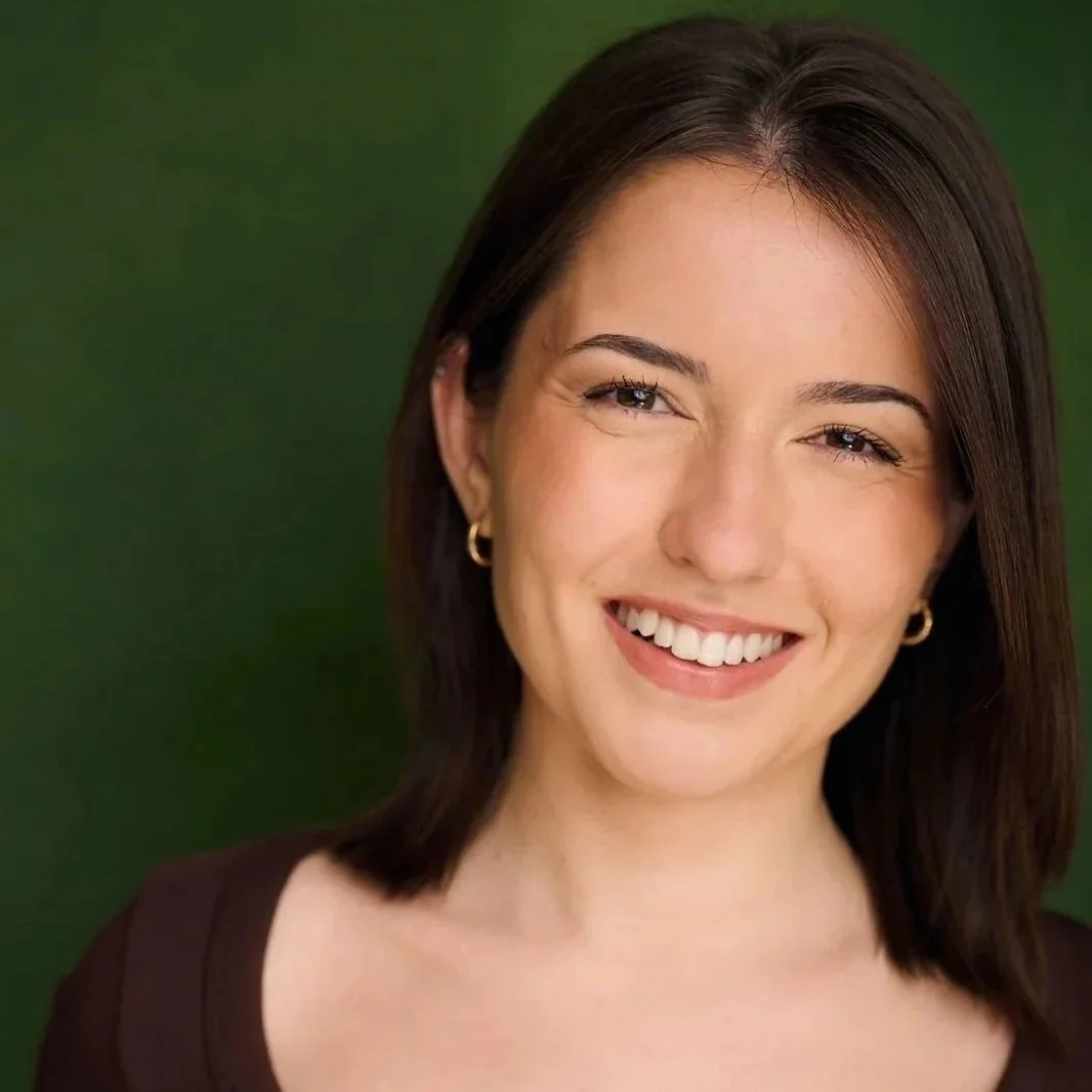 Retrato de una mujer con cabello castaño oscuro, sonriendo y usando aretes dorados, con fondo verde.