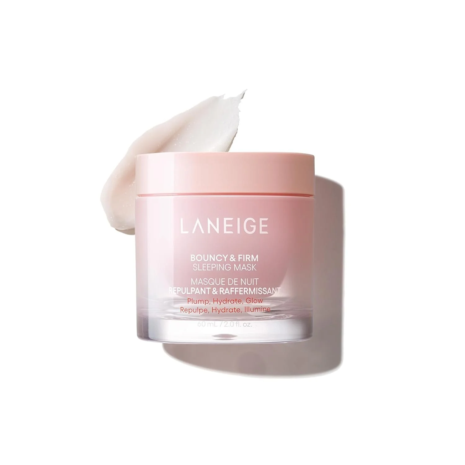 Pink jar of Laneige Bouncy & Firm Sleeping Mask with a dollop of white cream beside it, casting a shadow on a white background.