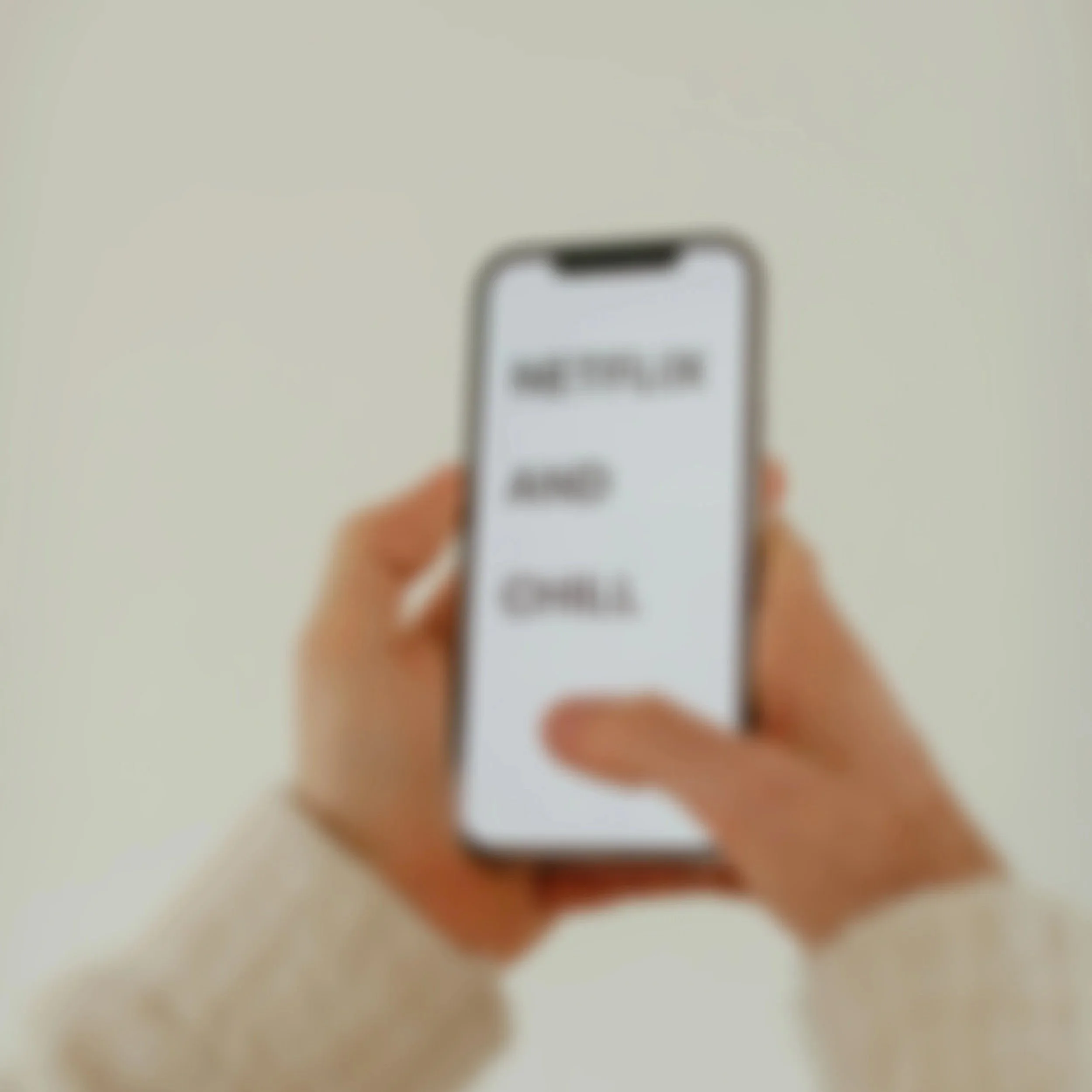 A person holding a smartphone with a blurred screen, against a plain white background.