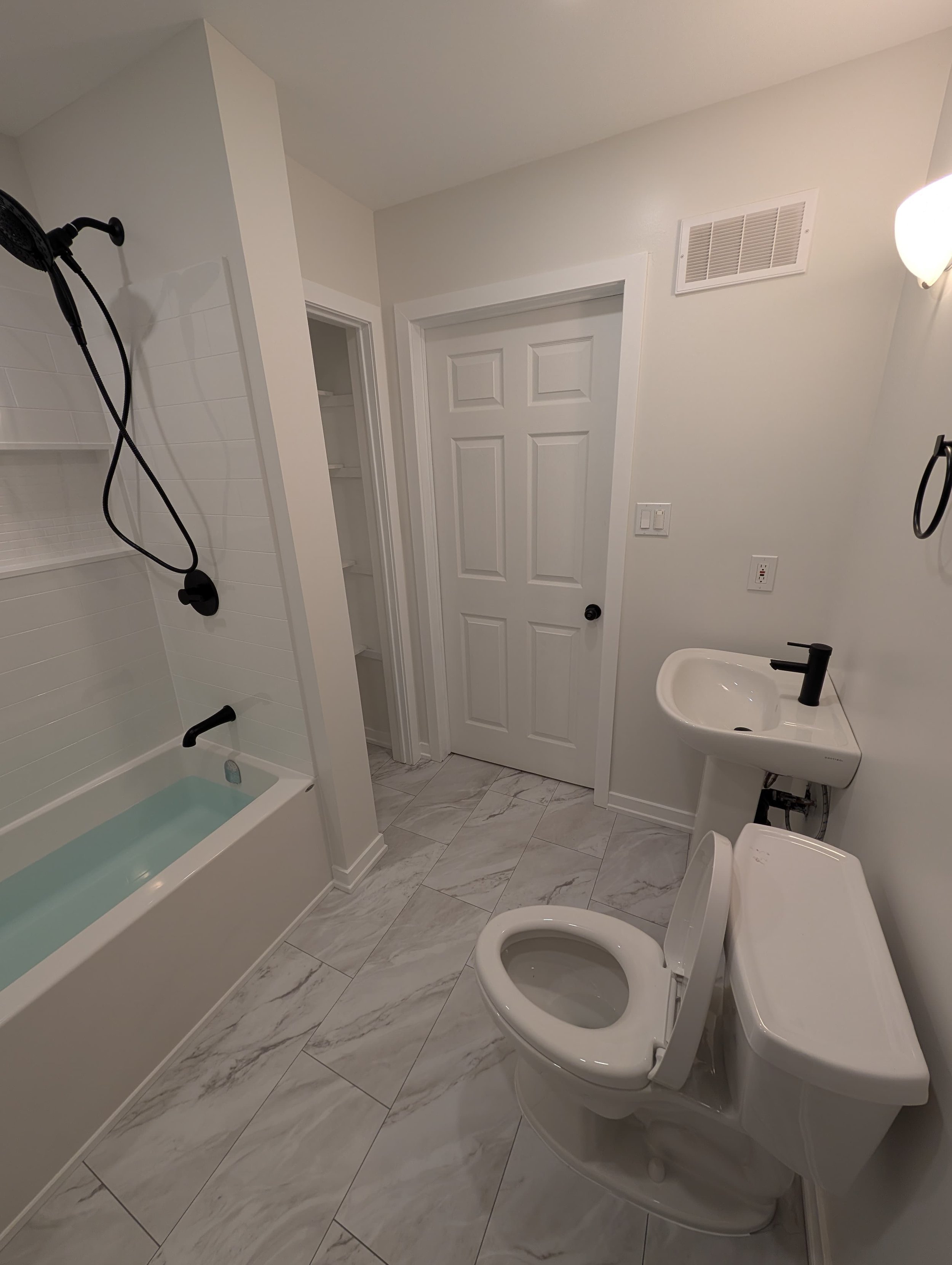 Bathroom renovation in Almonte with new bathtub, tile flooring, and updated fixtures