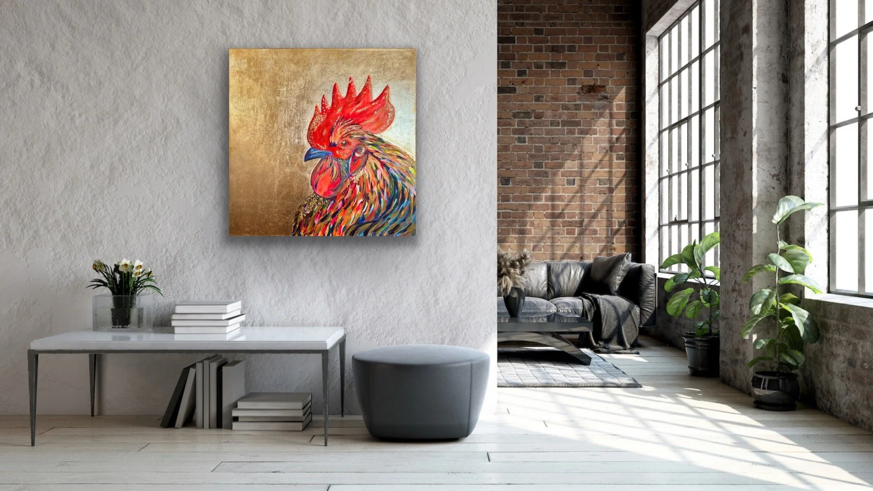 Interior of a modern industrial-style living room with a white textured wall, a colorful rooster painting, a white table with books and a plant, a gray ottoman, a black leather sofa, potted plants, large windows, and exposed brick and concrete walls.