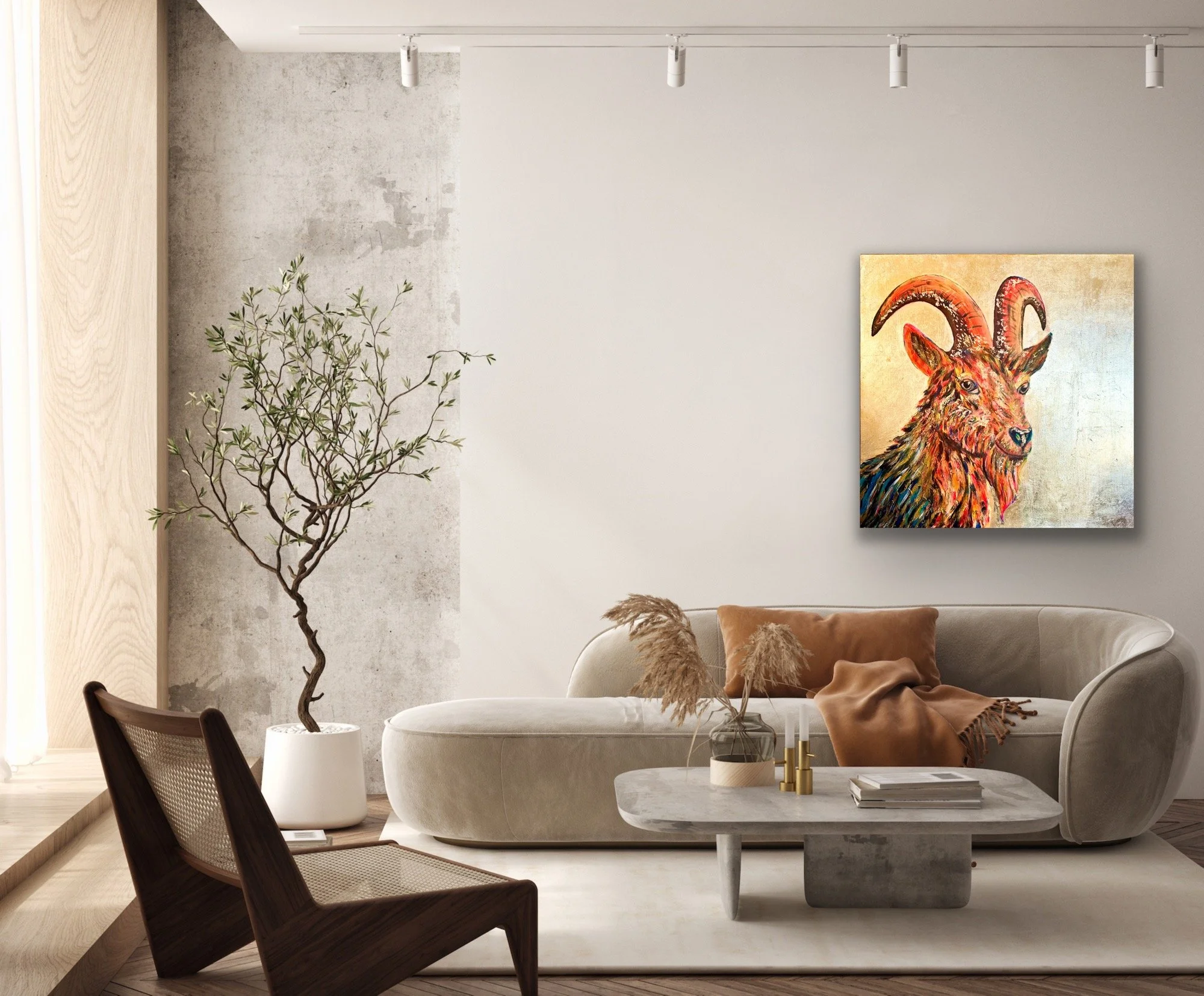 Modern living room with curved beige sofa, brown pillows, a white round coffee table with books and decor, a tall potted plant, and a colorful painting of a goat with large horns on the wall.