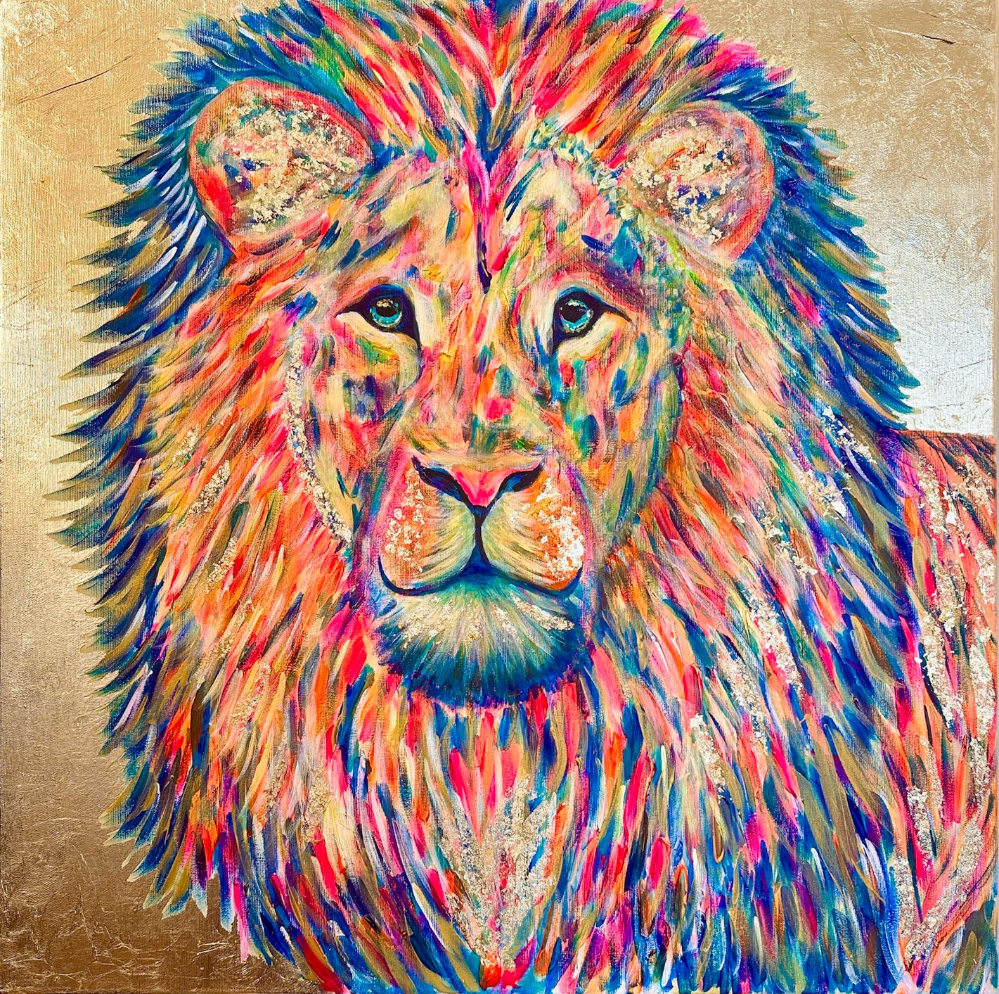 Colorful painting of a lion with a vibrant mane and a detailed face, featuring shades of pink, orange, blue, and yellow on a textured background.