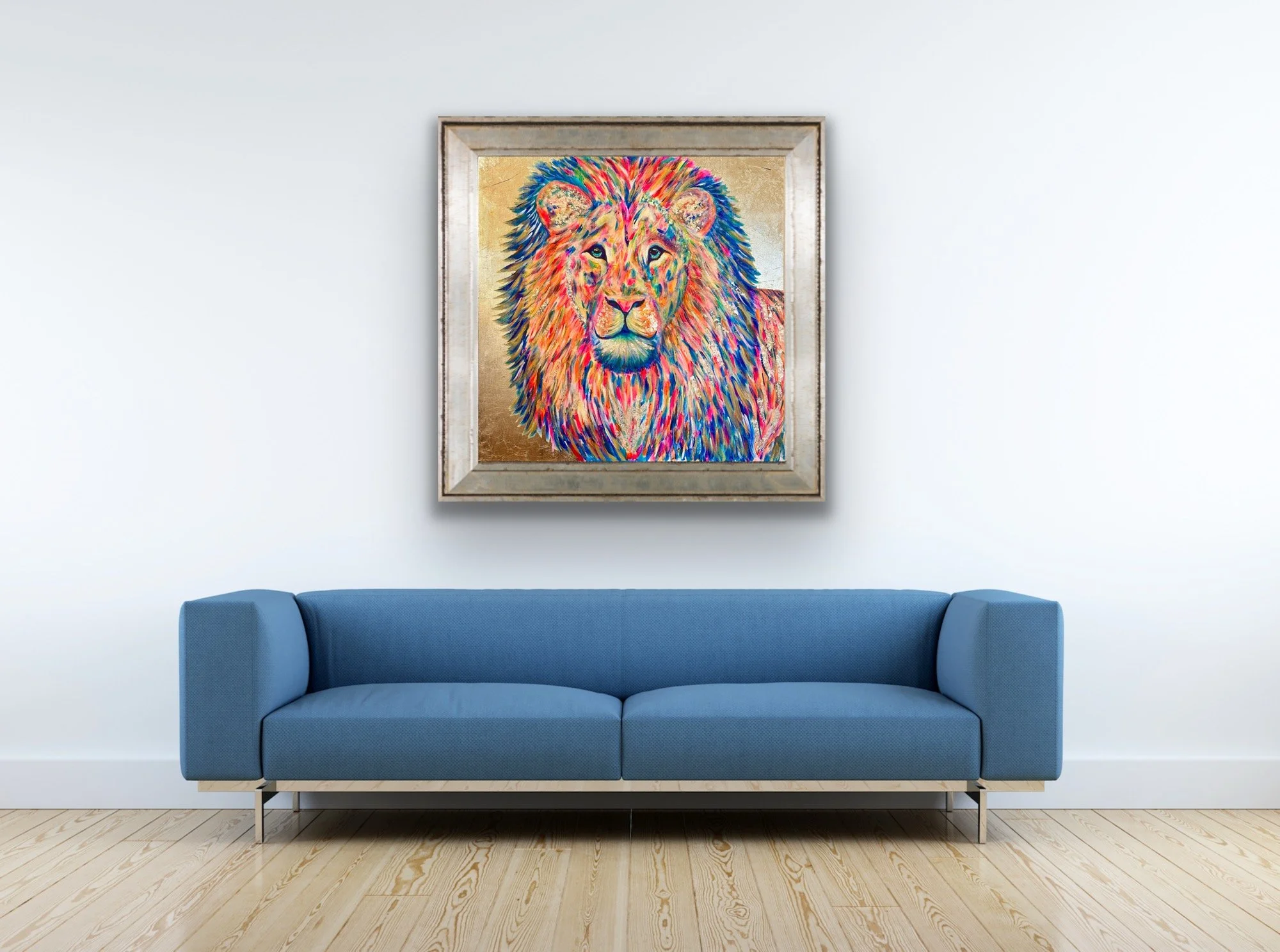 A modern living room with a blue sofa, wood flooring, and a colorful portrait of a lion hanging on the white wall.