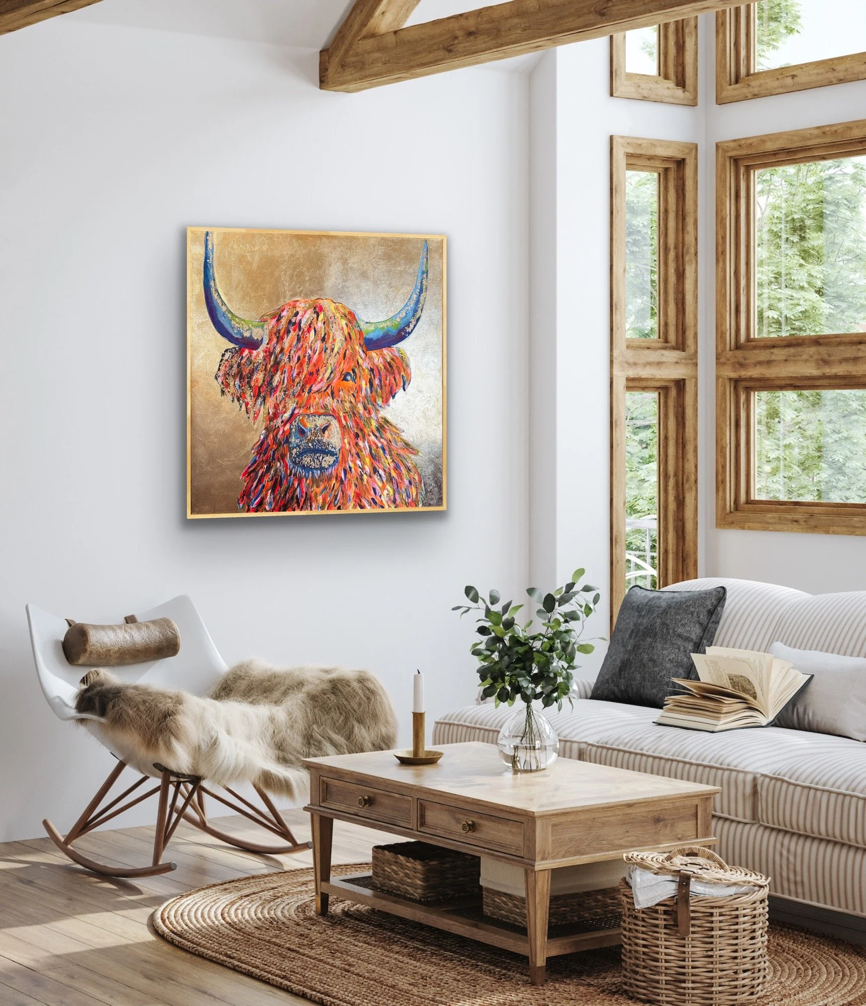 Living room with white walls, large windows, wooden accents, a striped sofa with pillows, a wooden coffee table with a vase and candle, a rocking chair with a sheepskin throw, a woven basket, and a colorful painting of a Highland cow hanging on the wall.