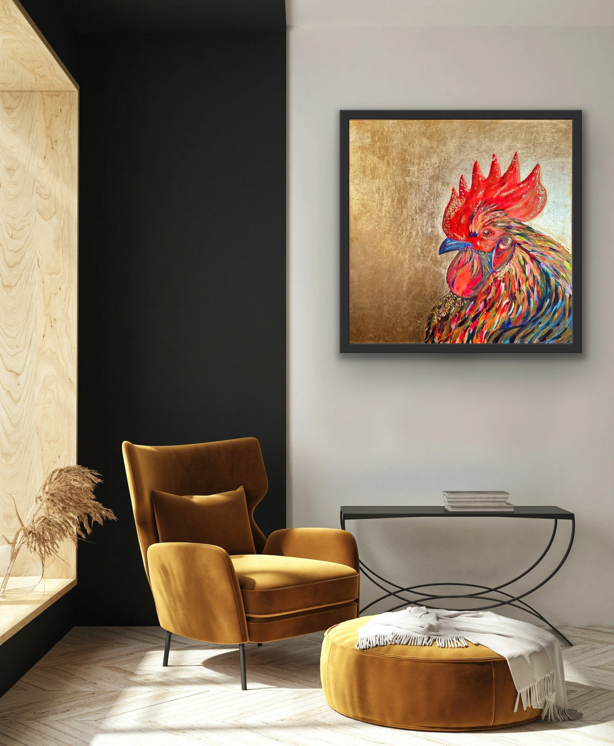 A cozy modern living room corner with a mustard velvet armchair, matching ottoman with a white throw blanket, a black metal side table with stacked books, a large colorful rooster painting on the wall, black and white walls, and a window with dried p