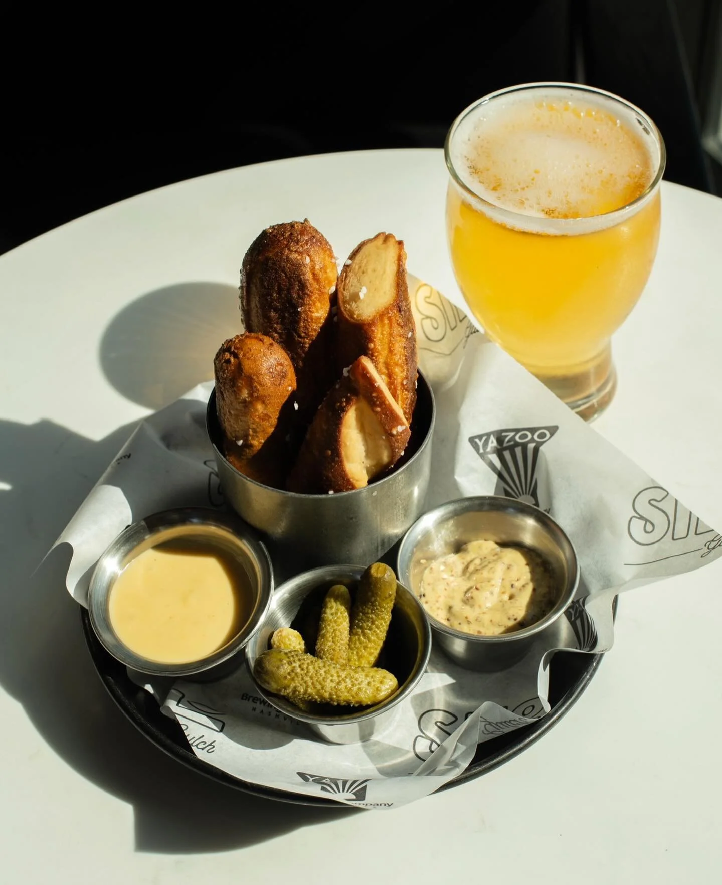 House-made pretzels, Yazoo beer cheese, whole grain mustard, and a crisp pour to match.