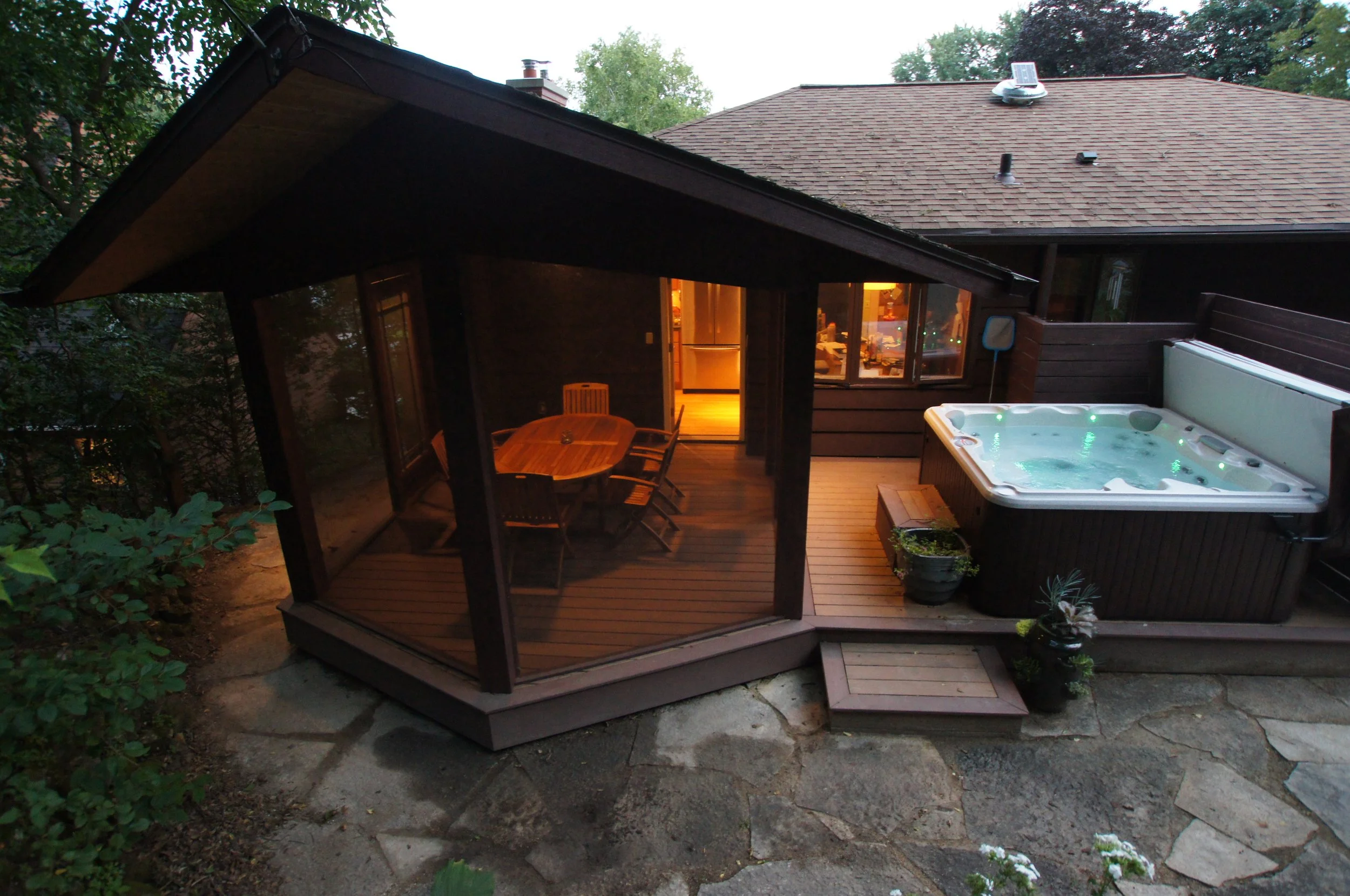 This screen porch addition is reminiscent of Frank Lloyd Wright's prairie style and blends indoors and outdoors for a relaxing experience.