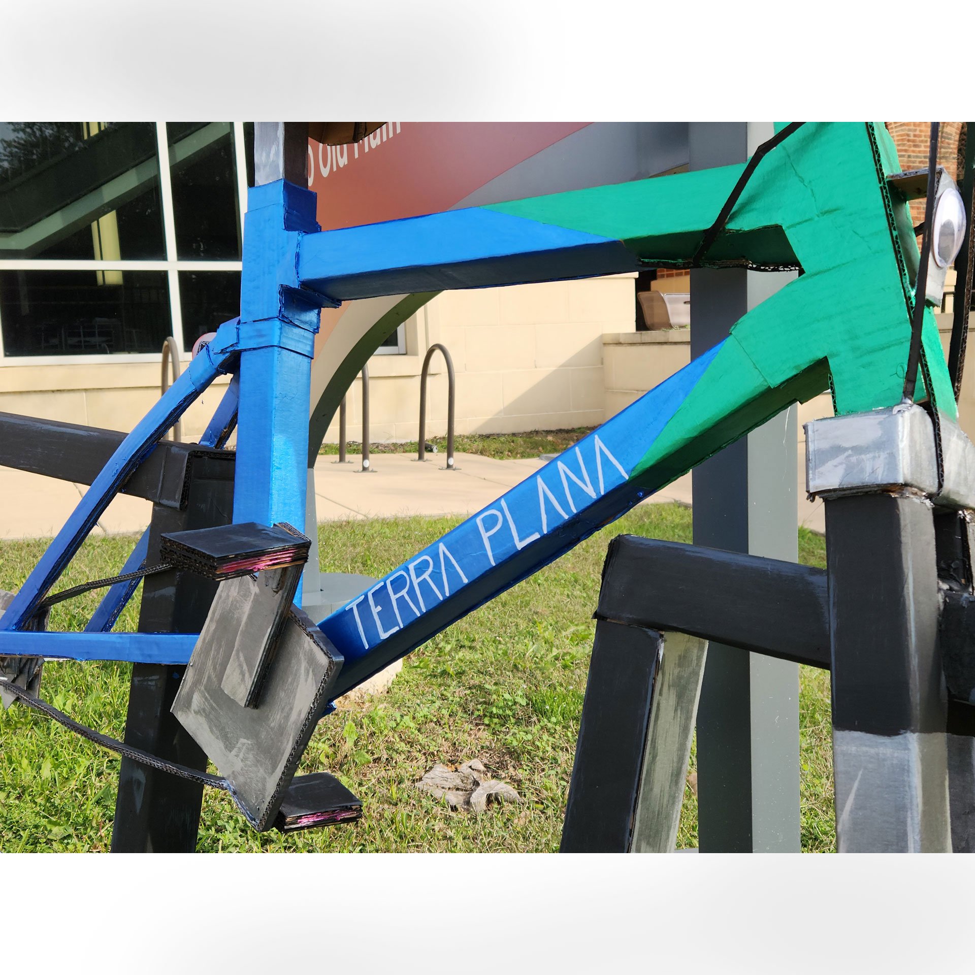 Terra Plana, 2025. Cardboard, hot glue, acrylic craft paint, googly eyes – 38 x 24 x 70 in.