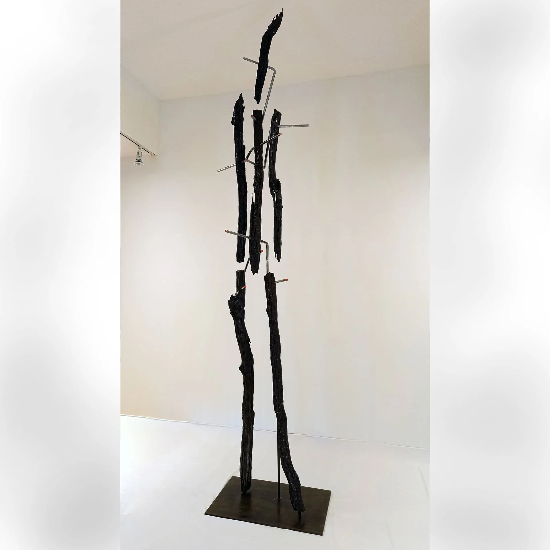 Untitled, 2025. Reclaimed bois d'arc fence posts, steel, epoxy resin, enamel paint – 162 (13.5ft) x 36 x 26 in.