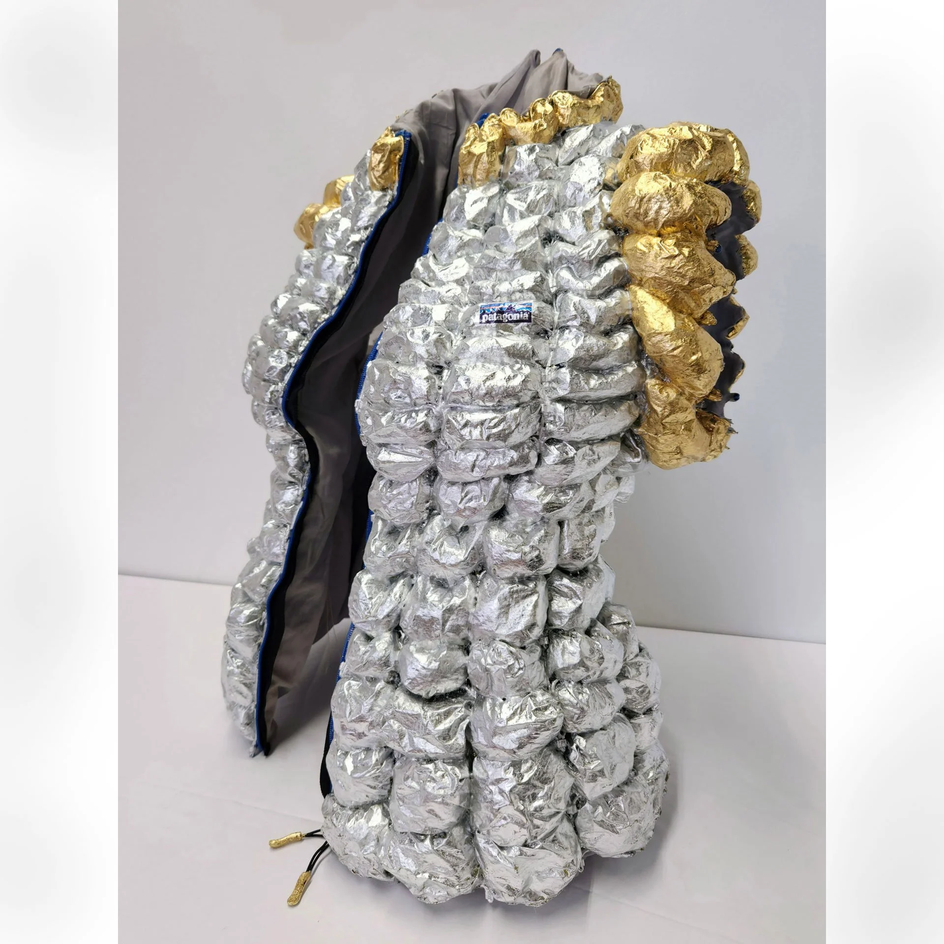 Wants and Needs, 2025. Paper, decoupage, metal foil, dress form, found materials – 25 x 20 x 15 in.