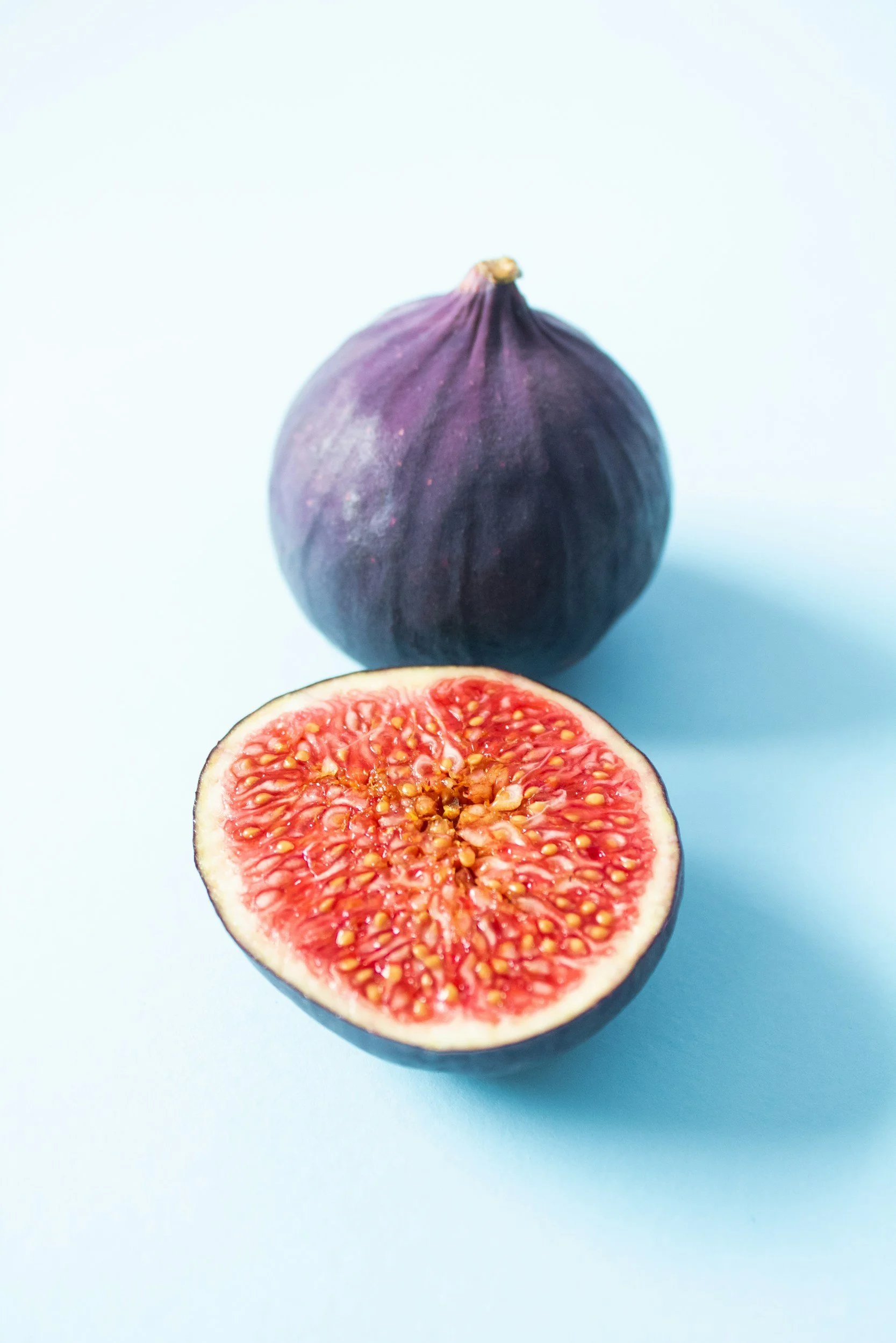 Image of a fig and one cut in half
