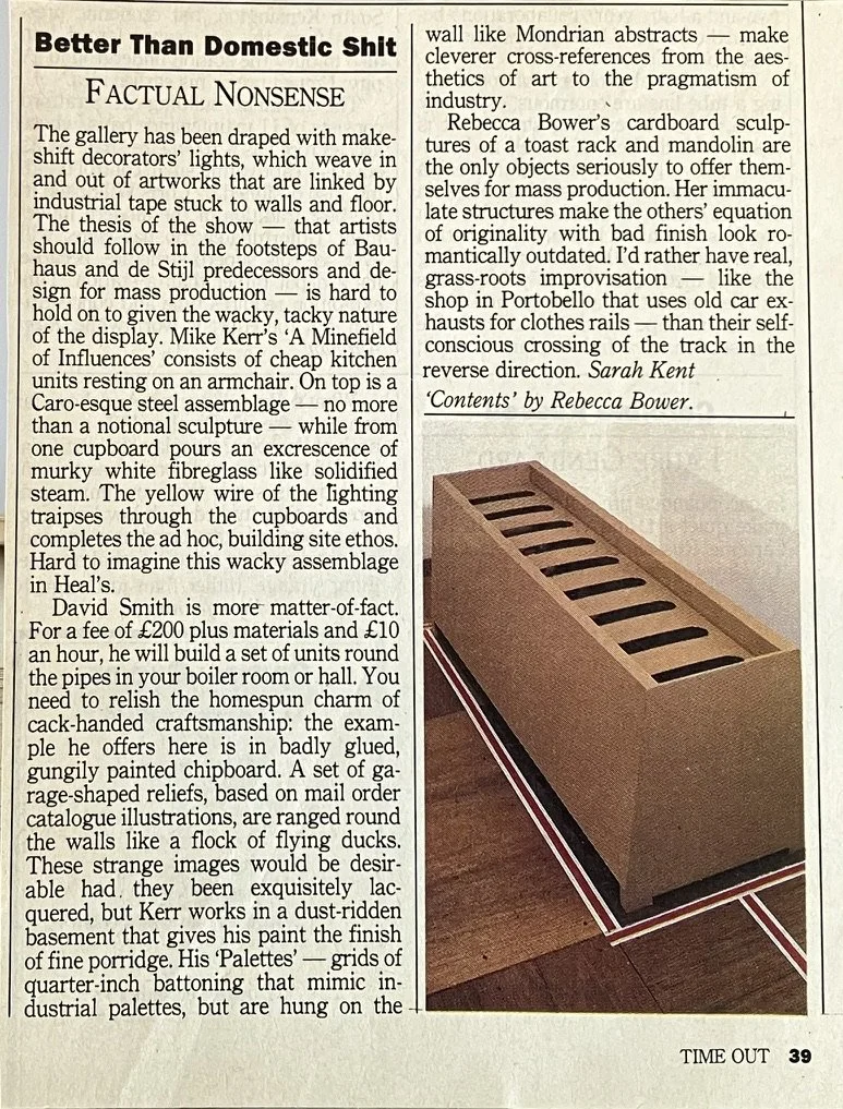 An oversized cardboard model of a kitchen toaster transformed into a sarcophagus, imprinted with romanesque arch interior