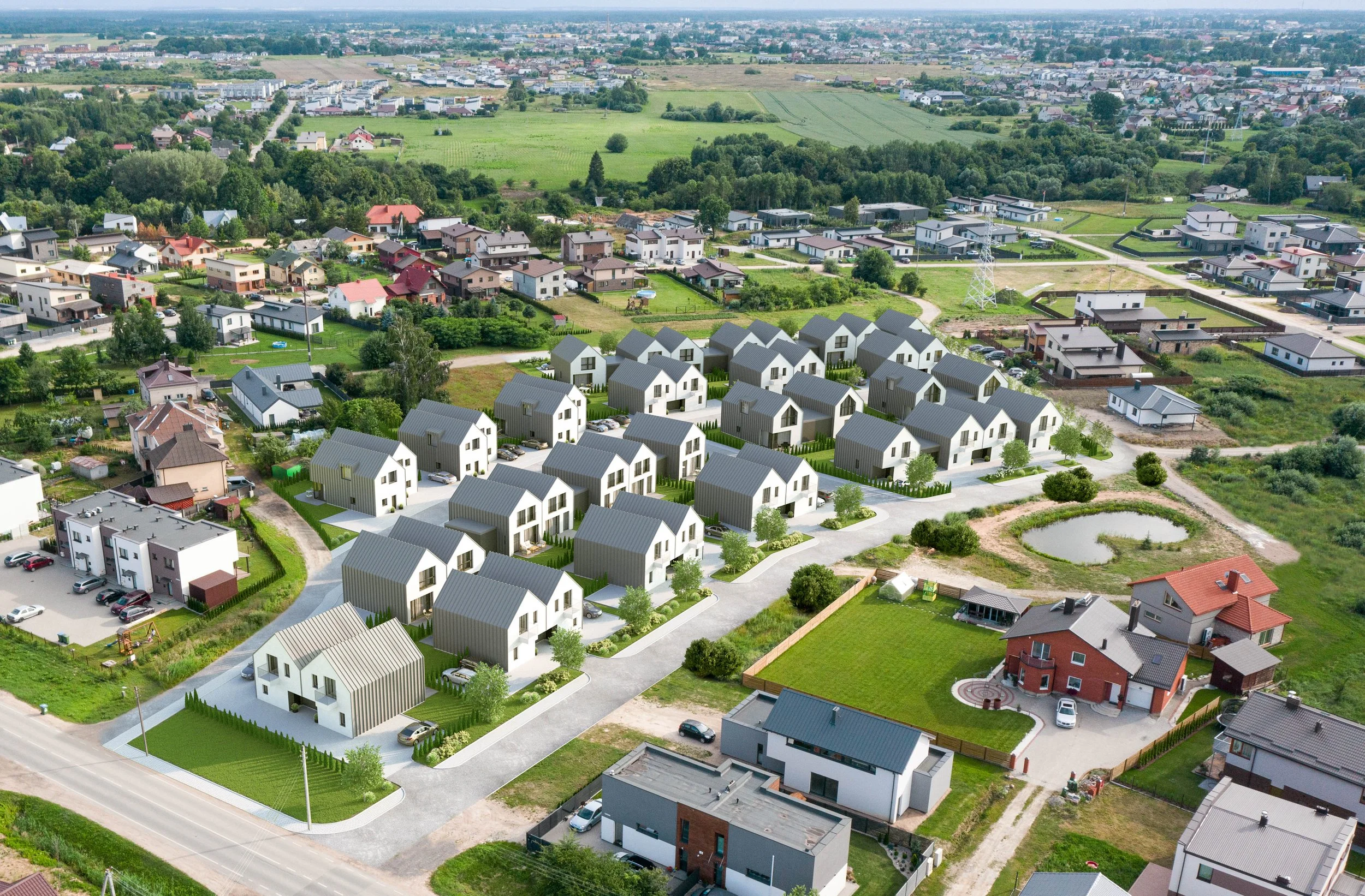 Aerial view of a modern residential neighborhood with newly built houses, green yards, a pond, and surrounding greenery.