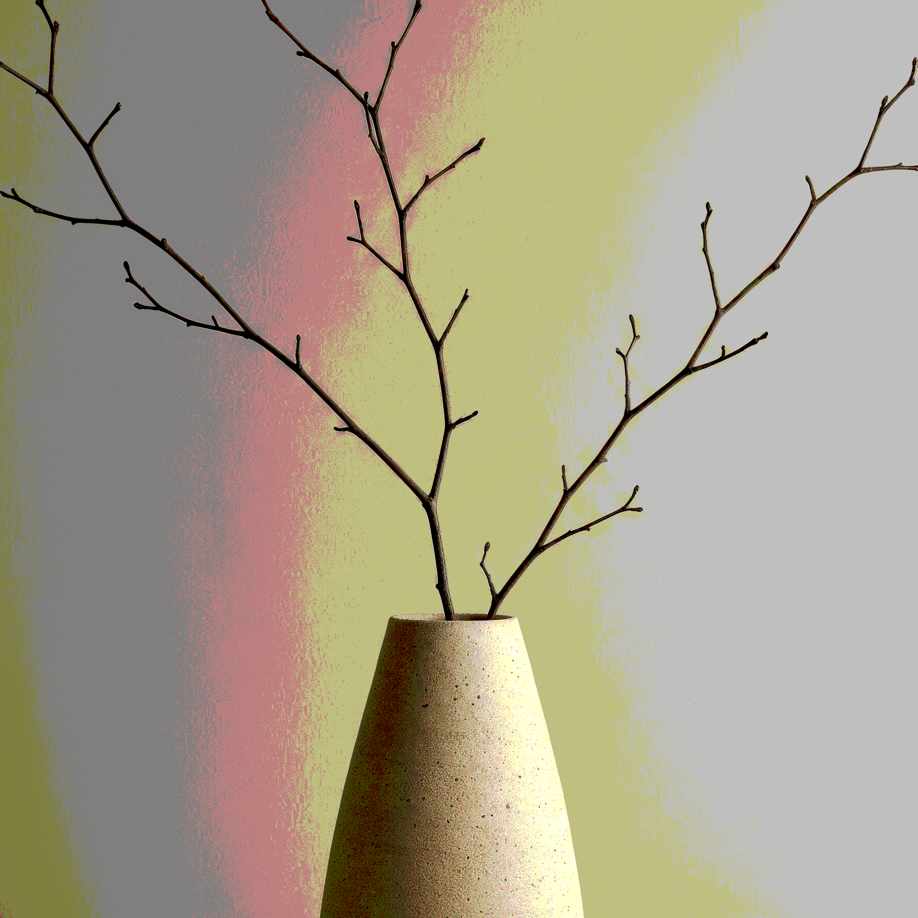 A beige textured vase with bare twig branches against a pastel-colored background with muted pink, yellow, and gray hues.