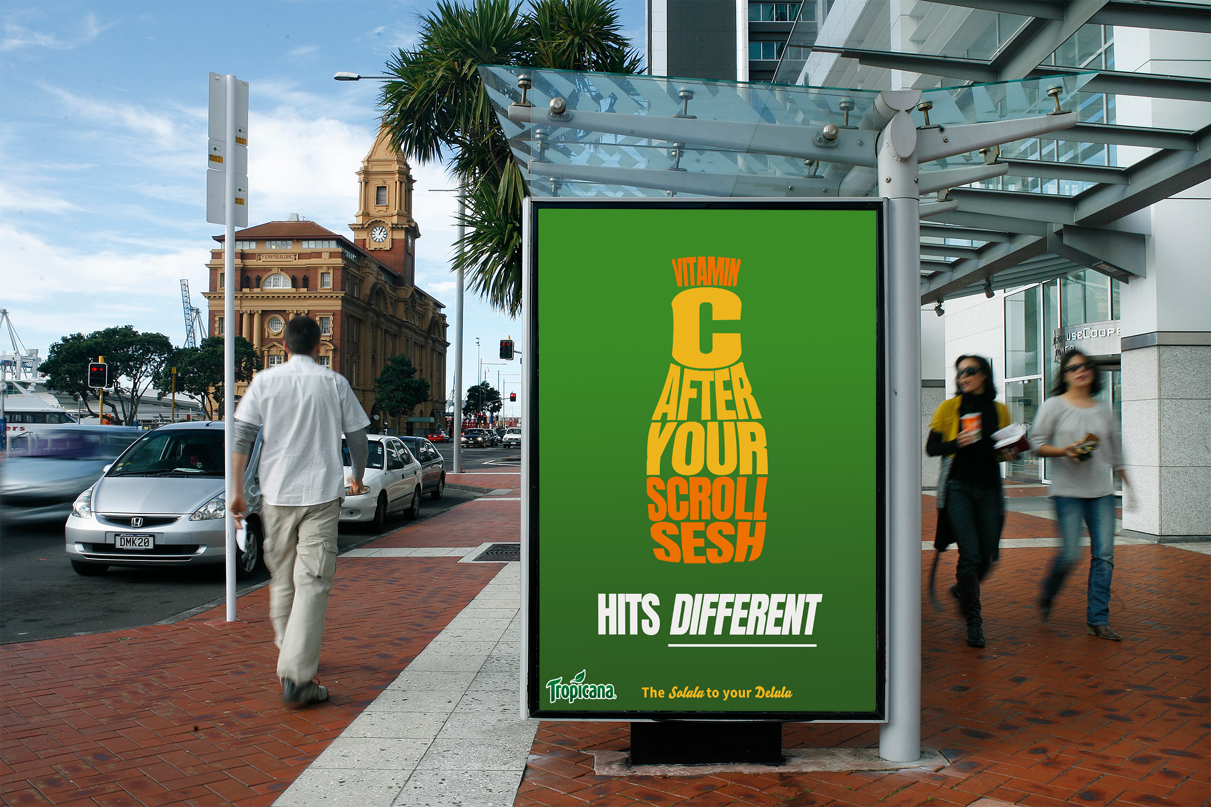 A large green billboard on a city sidewalk displaying an advertisement for Tropicana juice. The text is arranged in a shape resembling a squeezed orange and reads: 'VITAMIN C AFTER YOUR SCROLL SESH. HITS DIFFERENT. The Solulu to your Deli.'