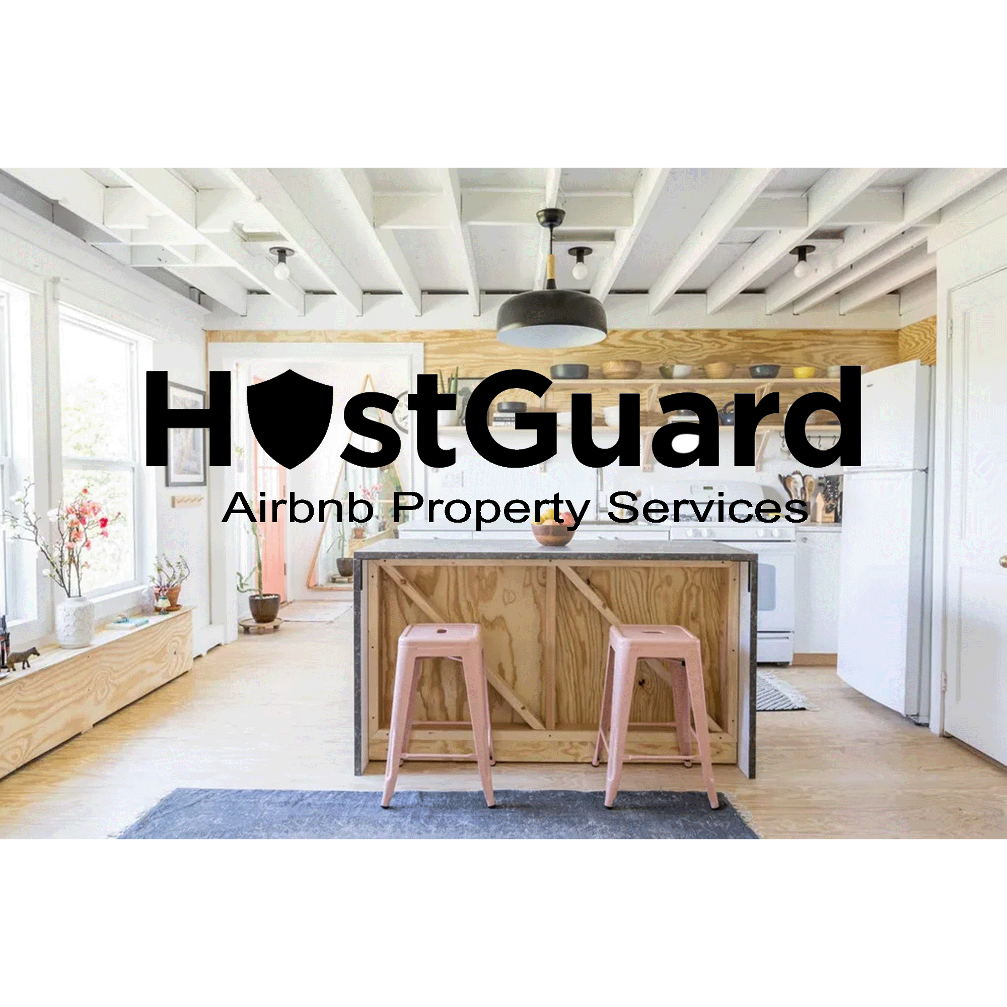 Bright kitchen with white cabinets, wooden accents, and pink stools with the logo 'HostGuard Airbnb Property Services' overlayed.