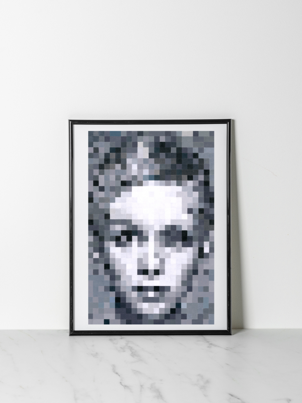 Pixelated black and white portrait of a woman's face in a black frame.