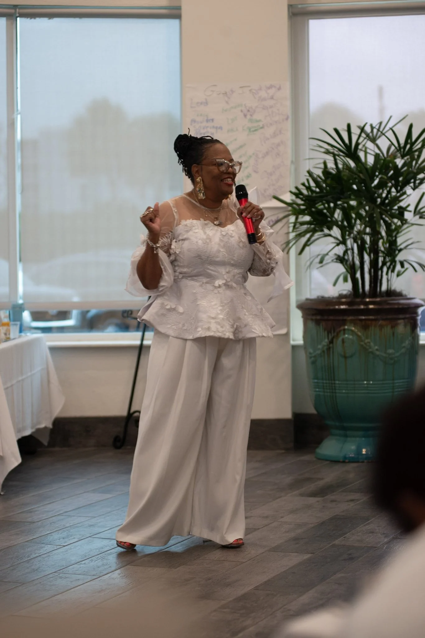 Woman speaking passionately during a marriage retreat session, sharing encouragement and faith-based teaching.