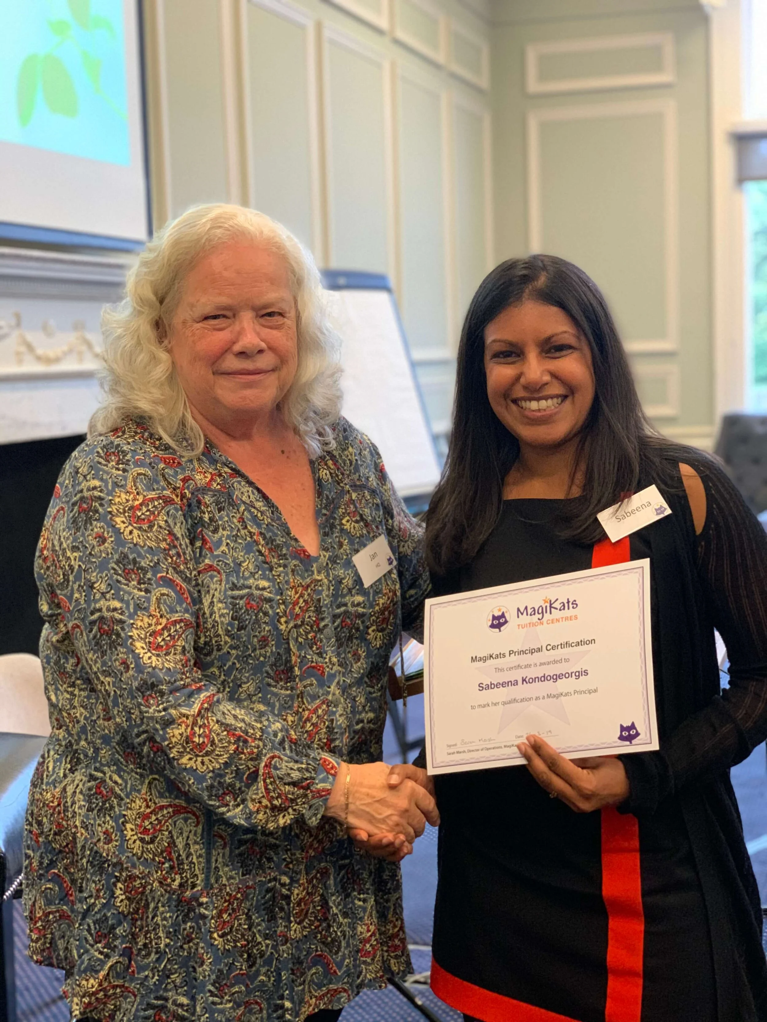 Sabeena receiving her MagiKats Qualification certificate