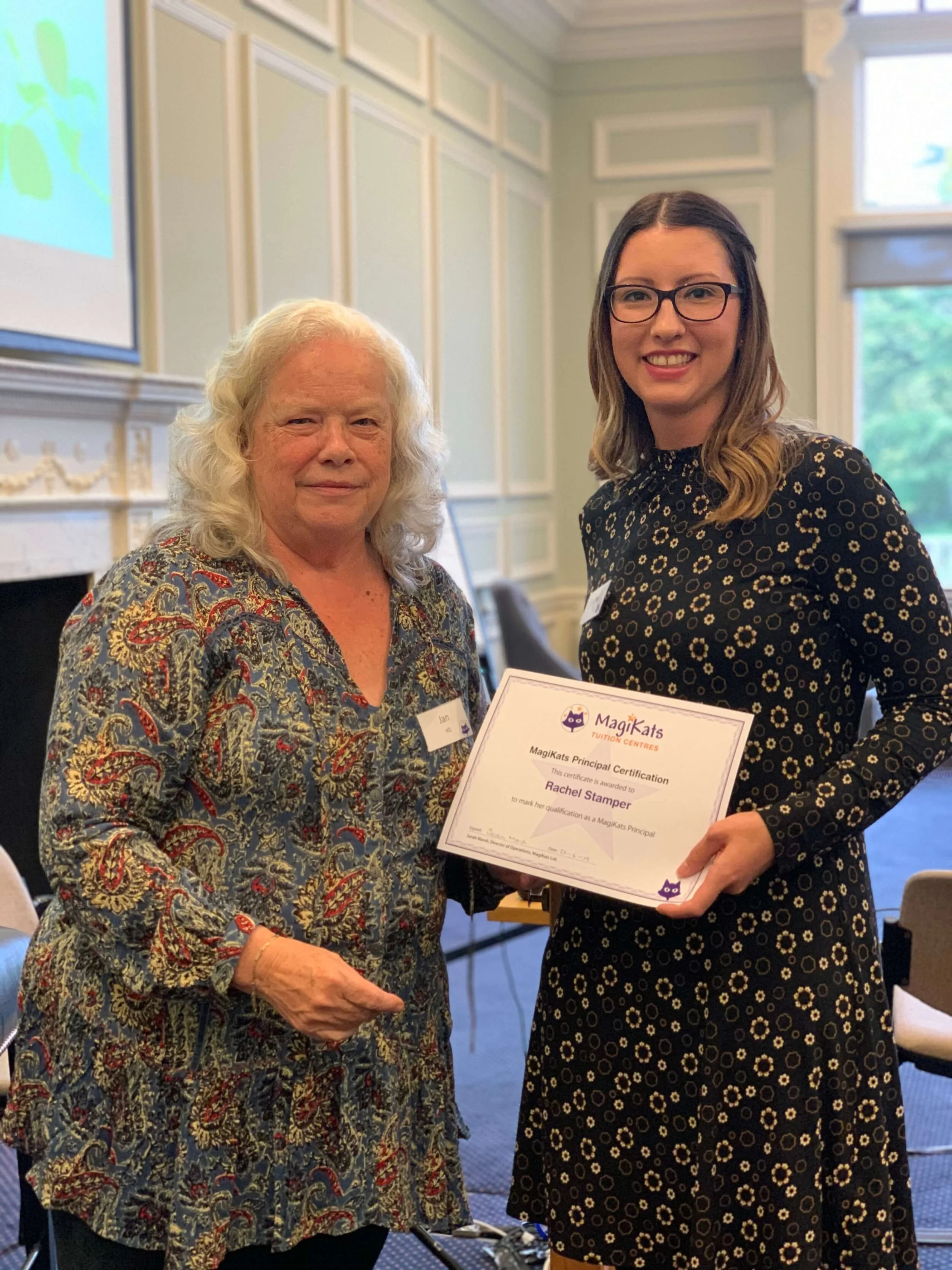Rachel receiving her MagiKats Qualification certificate