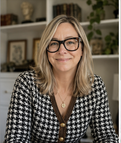 a woman sitting in front of bookcase wearing glasses and houndstooth sweater