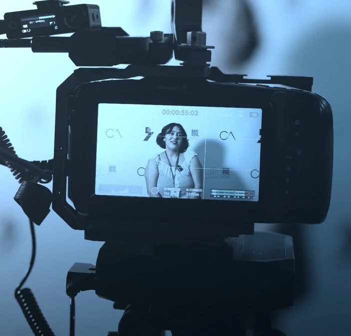 Camera monitor framing a filmmaker interview