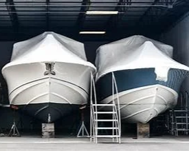 to shrink wrapped boats ready to be stored for winter.