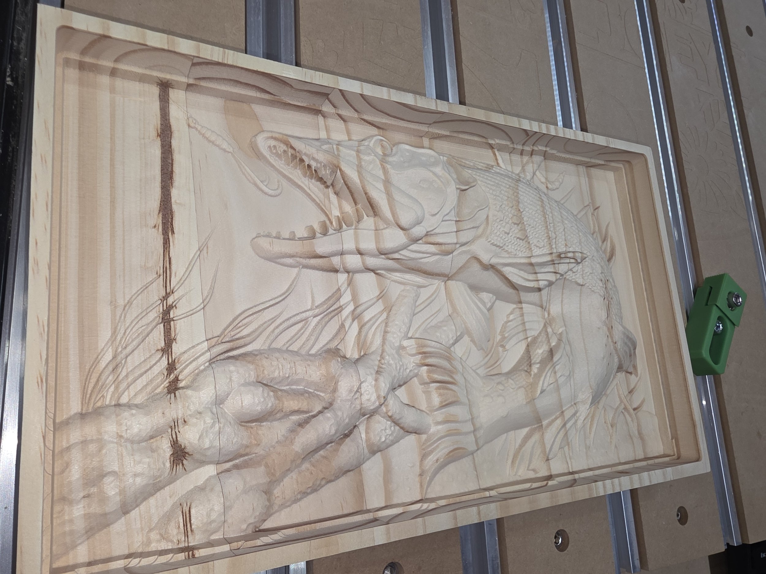 Wooden carving of a dinosaur, specifically a Tyrannosaurus rex, with detailed textures and background, placed on a workbench.