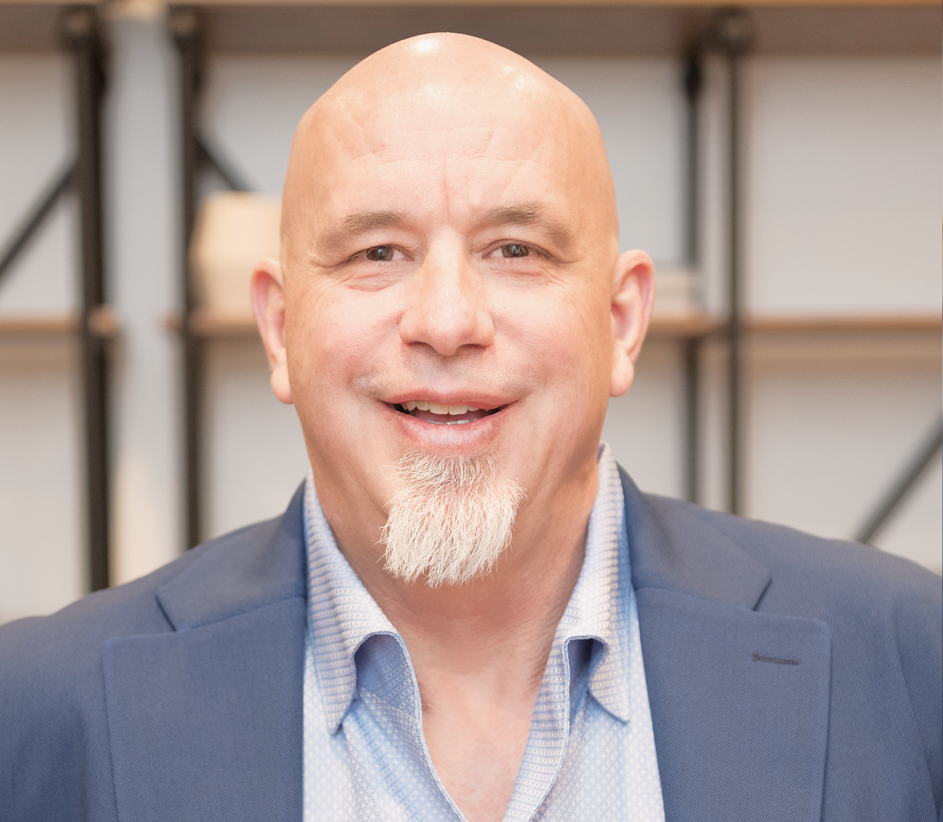 A care professional smiling at the camera in a bright, welcoming indoor setting.