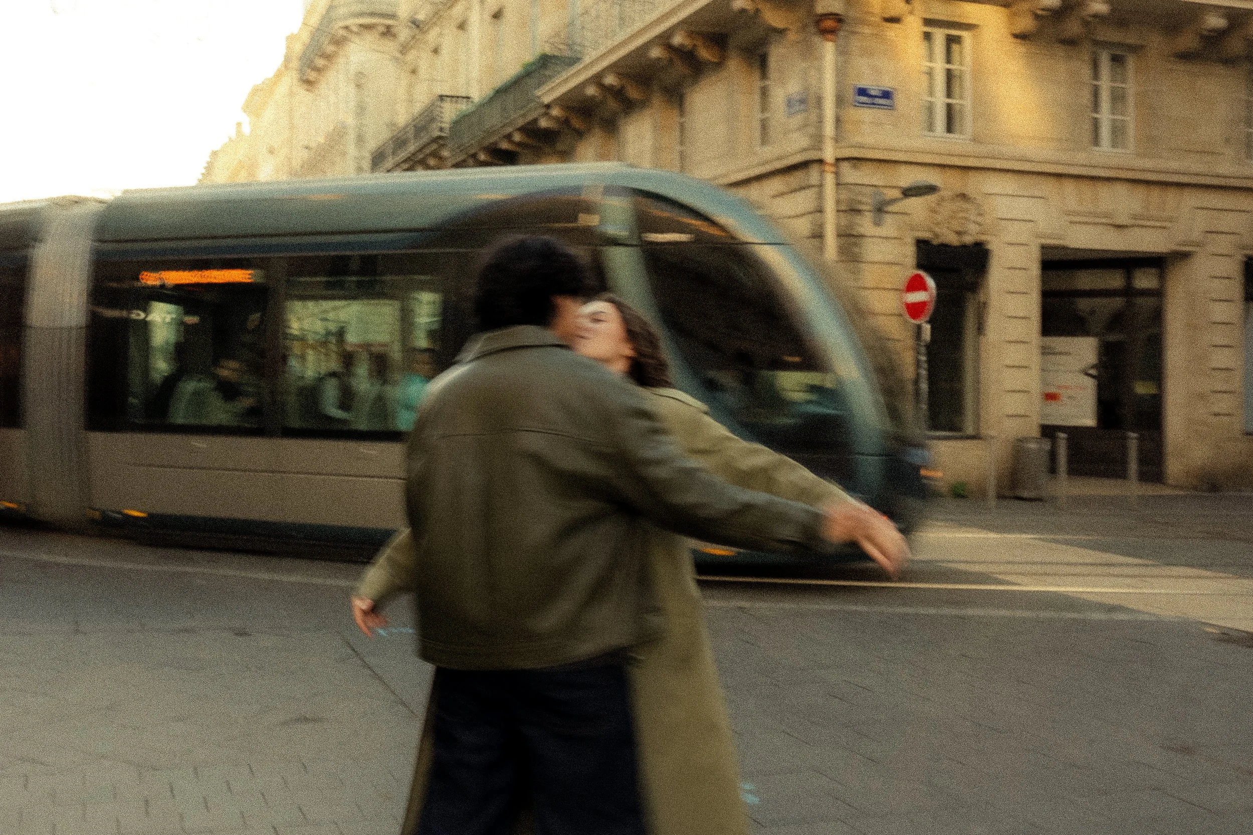 un couple s'embrasse dans les rue de bordeaux devant le tram 