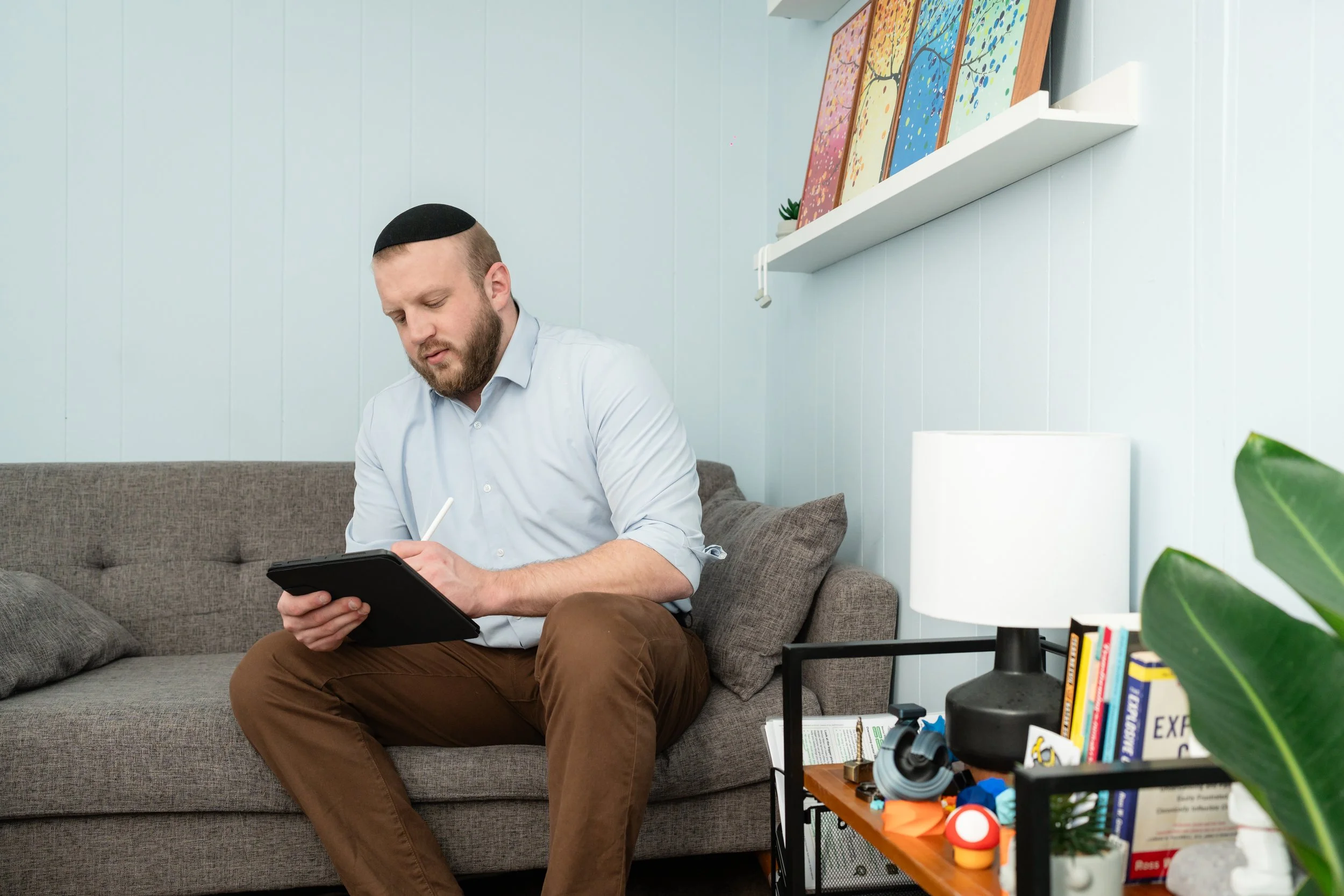 Psychologist taking notes during therapy session in private practice office