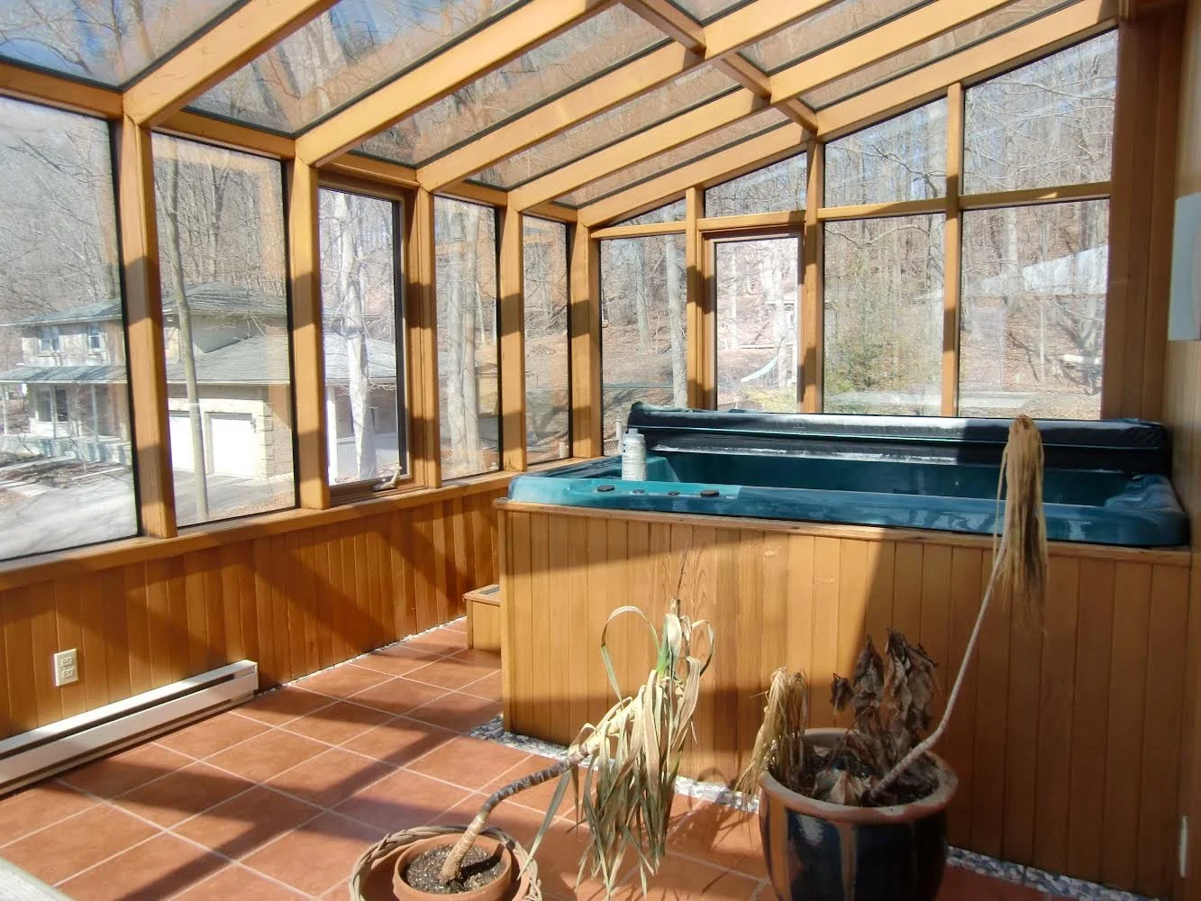 Before picture of upper floor with hot tub, illustrating drainage issues in the home's original state prior to renovation.