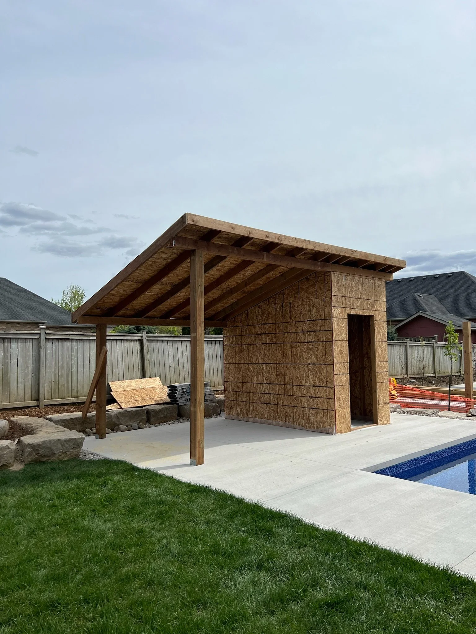 In-progress construction of pool shed in Kilworth by Burcon Construction, showcasing framework and structural elements.
