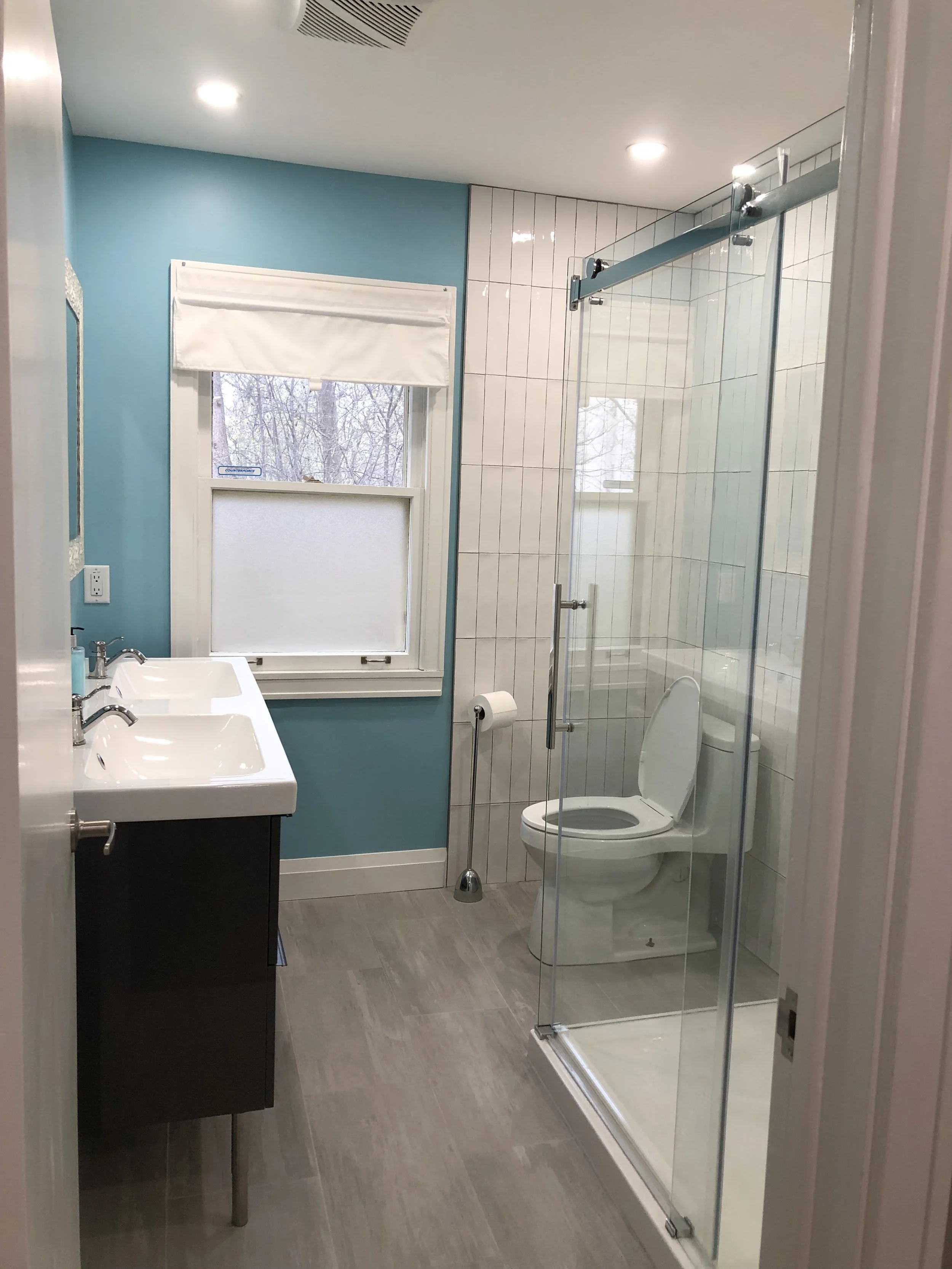 Completed upper level bathroom renovation in London by Burcon Construction, showcasing modern fixtures and design.