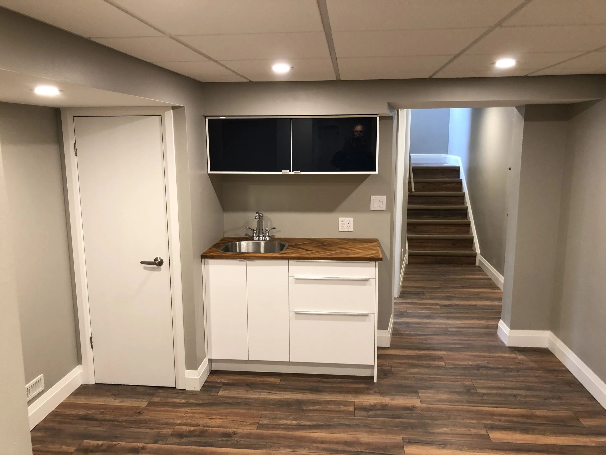 Completed basement kitchenette in London by Burcon Construction, providing convenience and functionality for tenants.