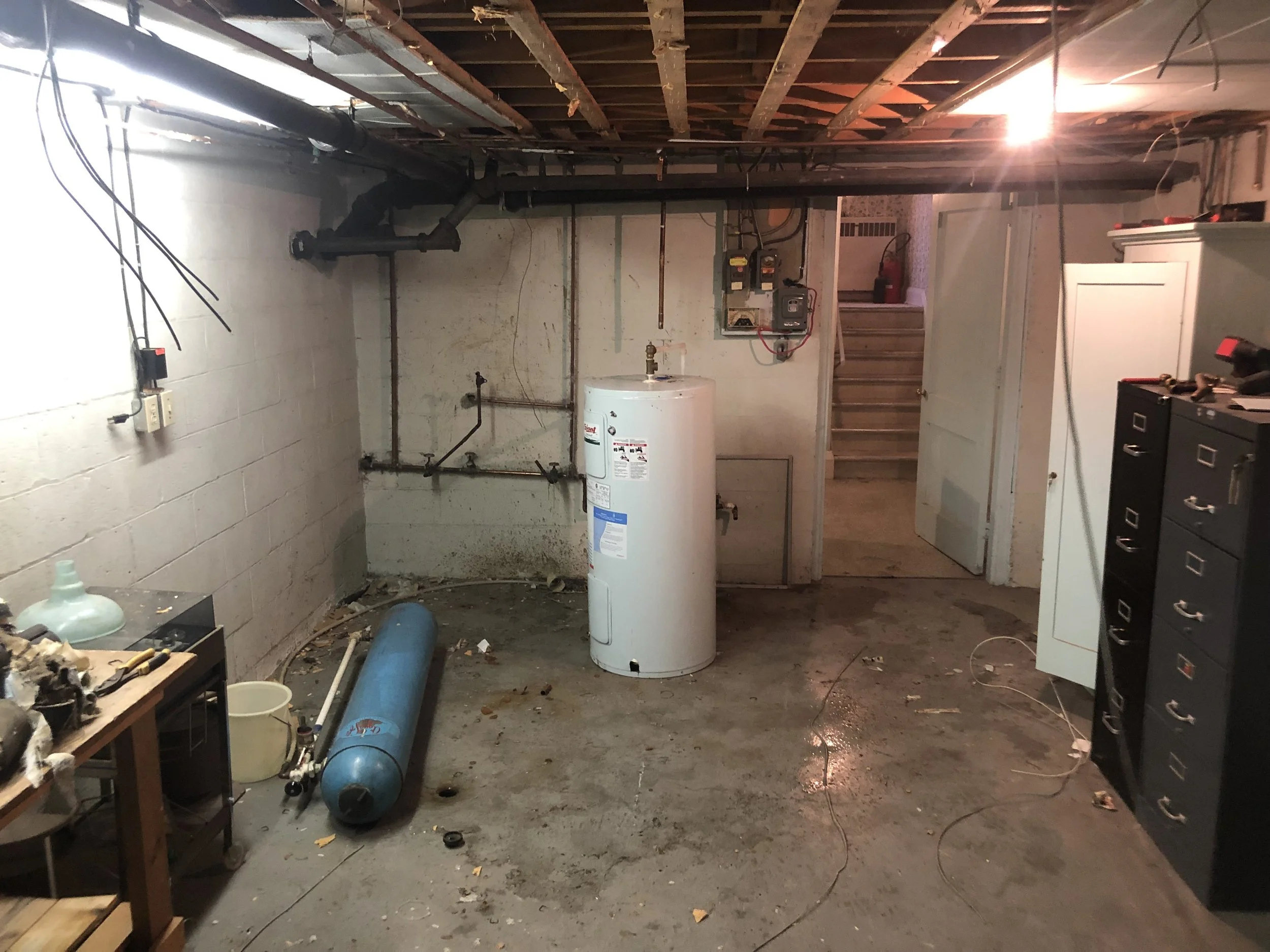 Before picture of unfinished basement in London prior to renovation by Burcon Construction, highlighting the space awaiting transformation.